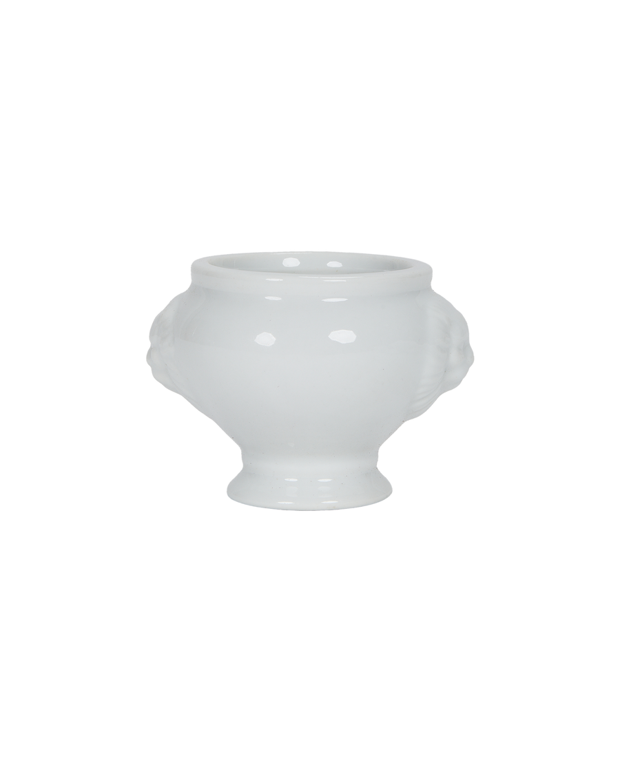 Vintage French milk glass lion-head salt cellar, featuring recessed carvings for design.