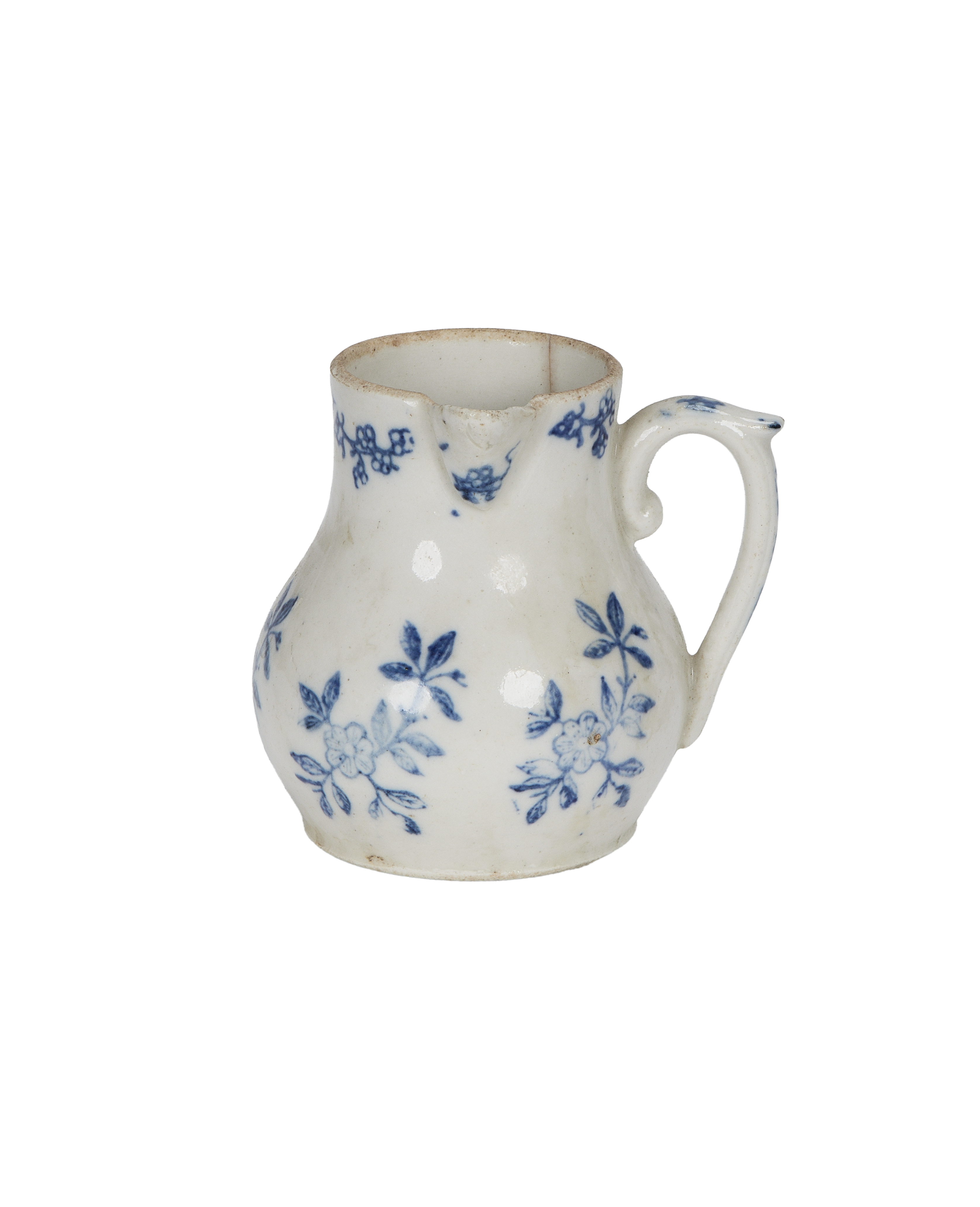 Vintage French white ceramic creamer with blue floral design and rustic condition.