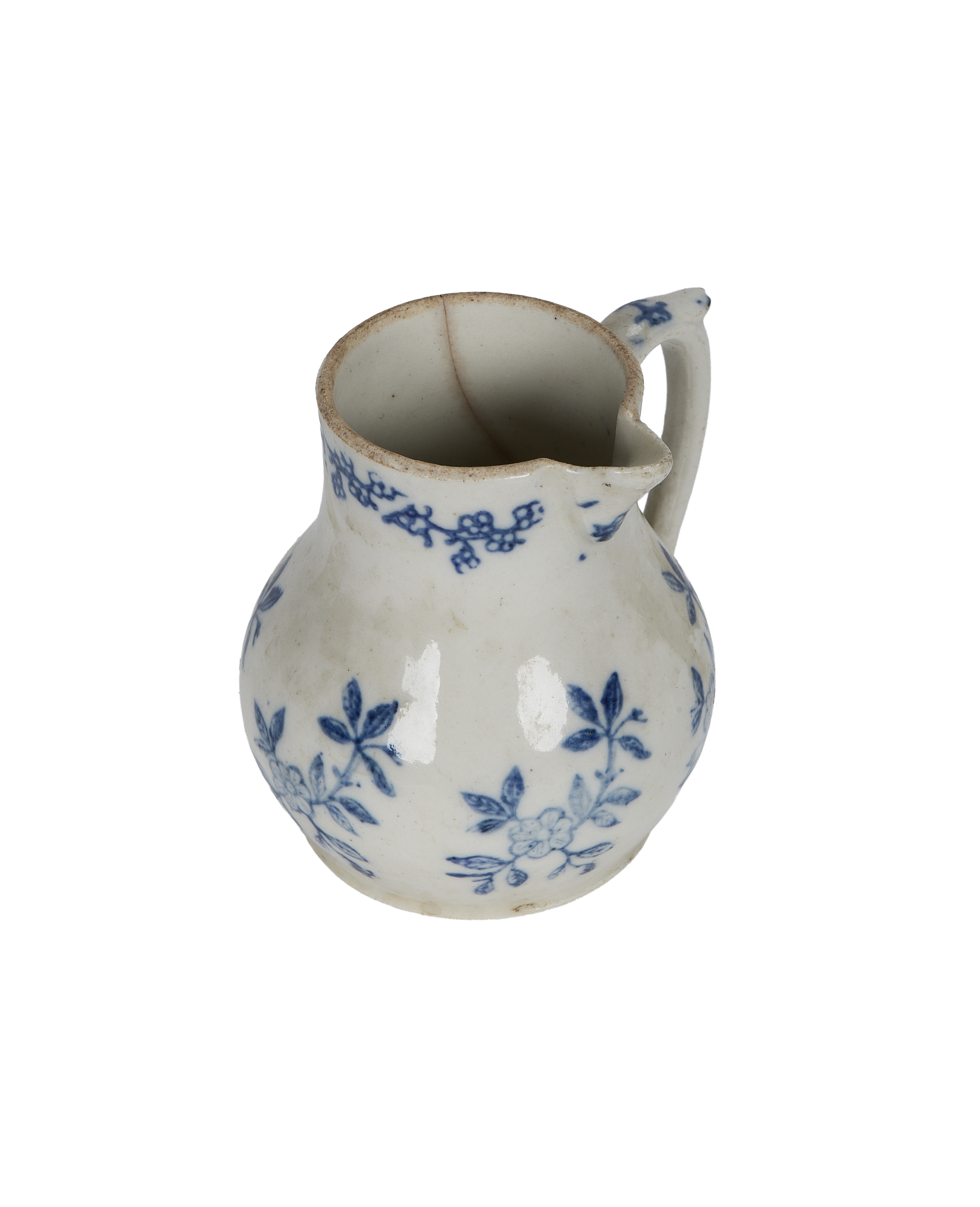 Vintage French blue floral creamer, showing crack and aged rim detail.