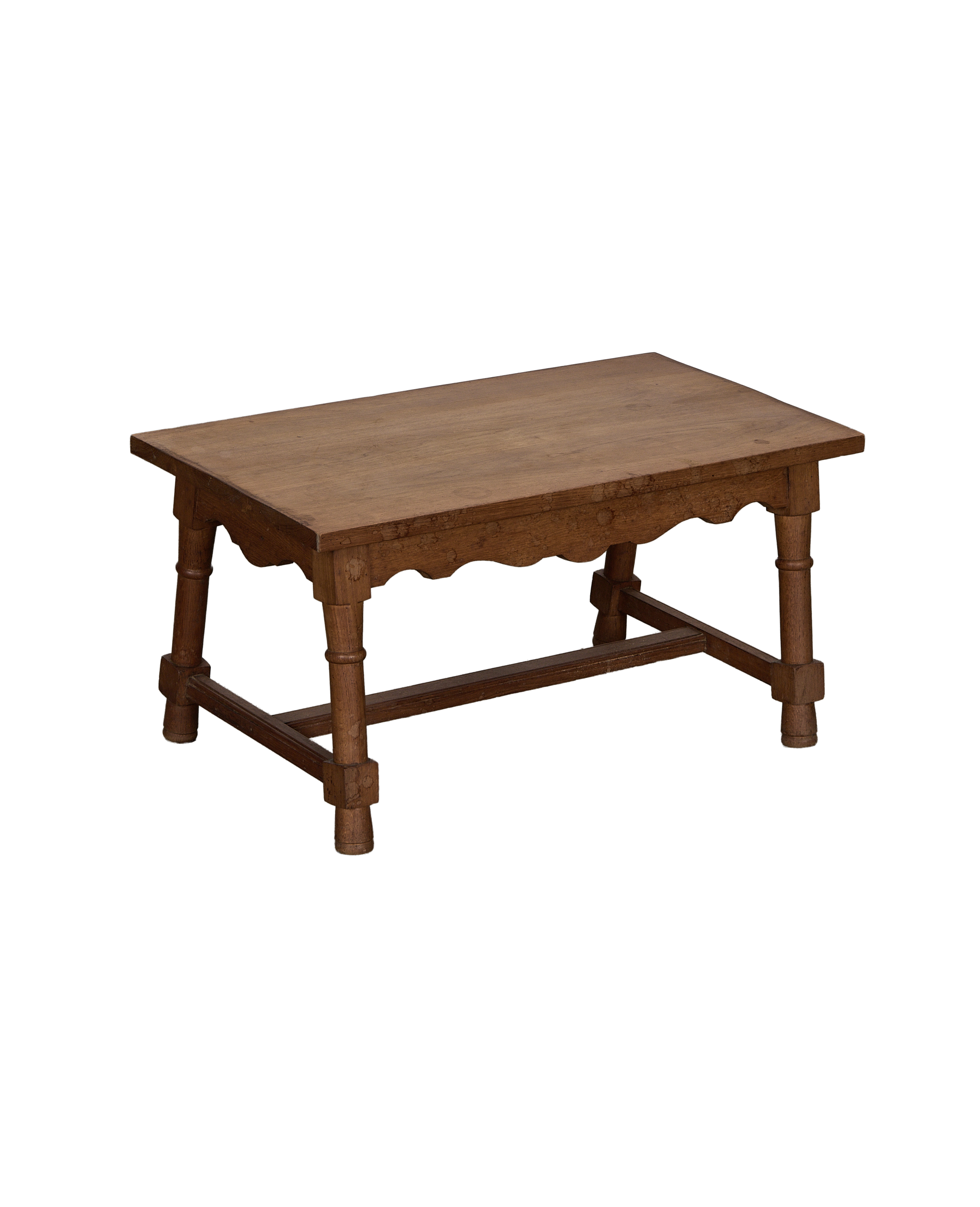 Vintage French oak coffee table with decorative carved skirt and turned legs.