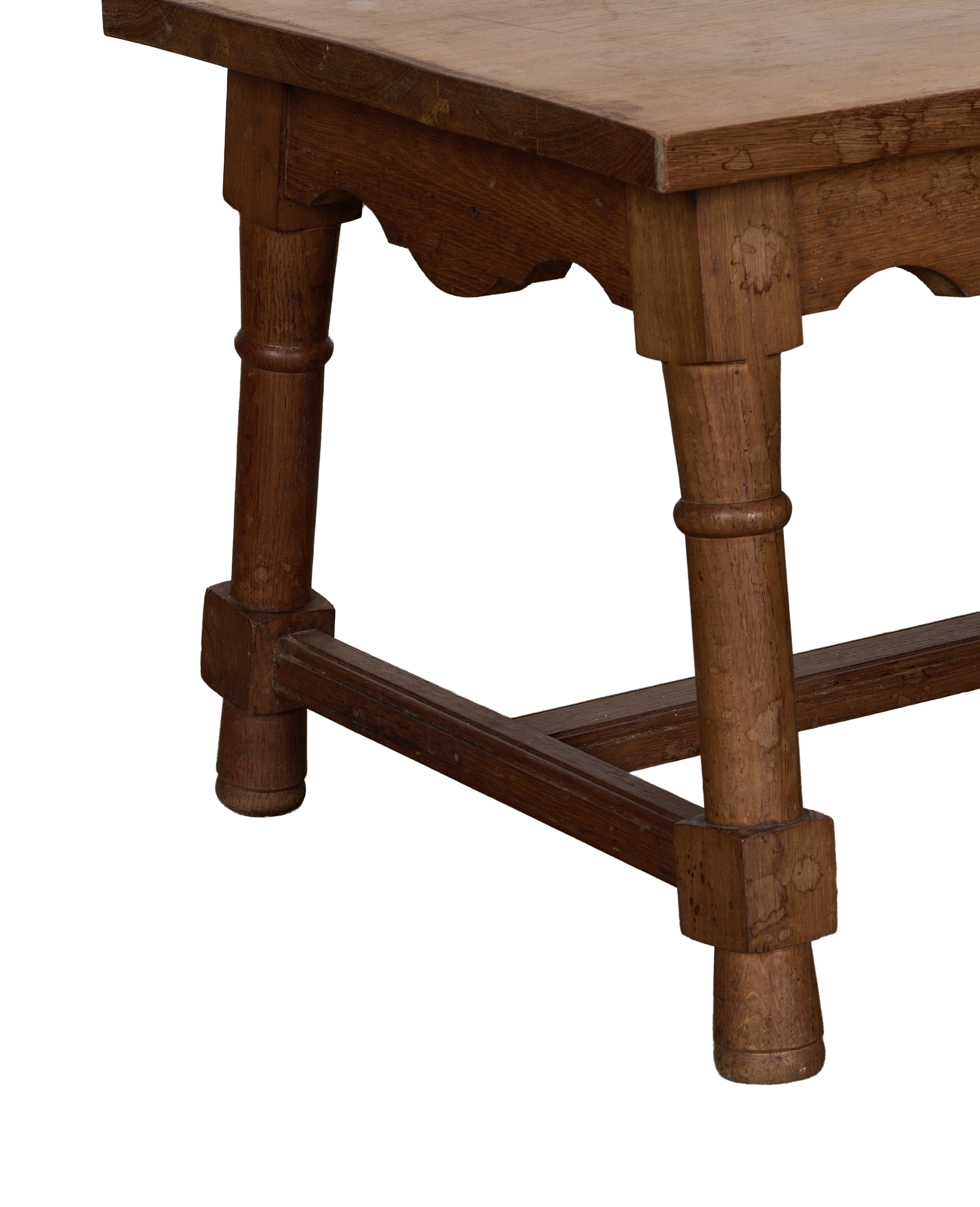 Vintage French oak coffee table showcasing detailed side frame and turned leg.