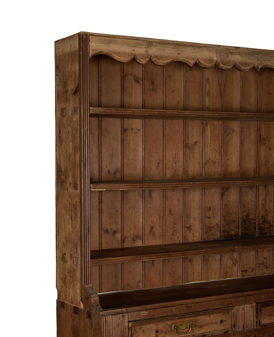 Vintage French oak china cabinet with scalloped top, open shelves, and carved wood details.