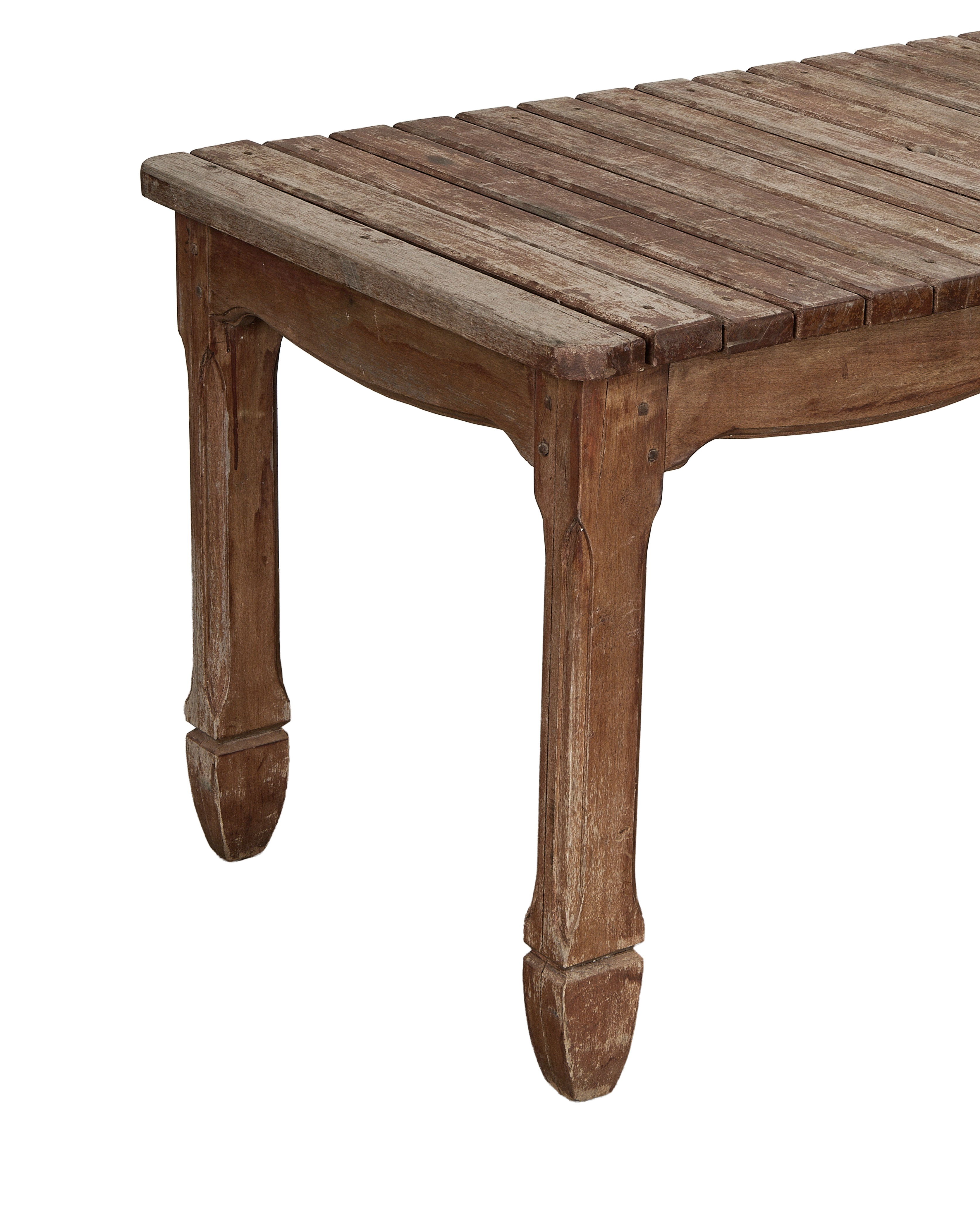 Vintage French oak patio table's slatted top and carved legs, showing distressed wood texture.