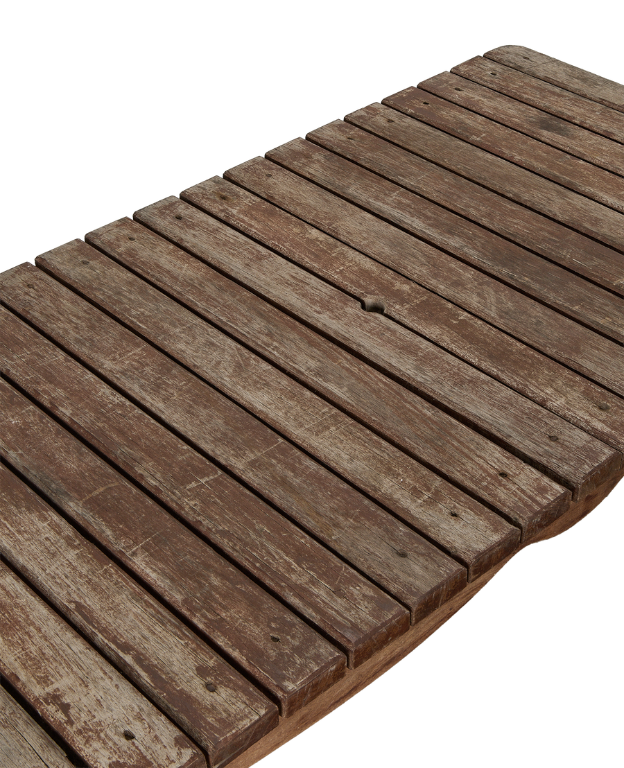 Vintage French oak patio table, rustic aged wood planks, close-up texture detail.