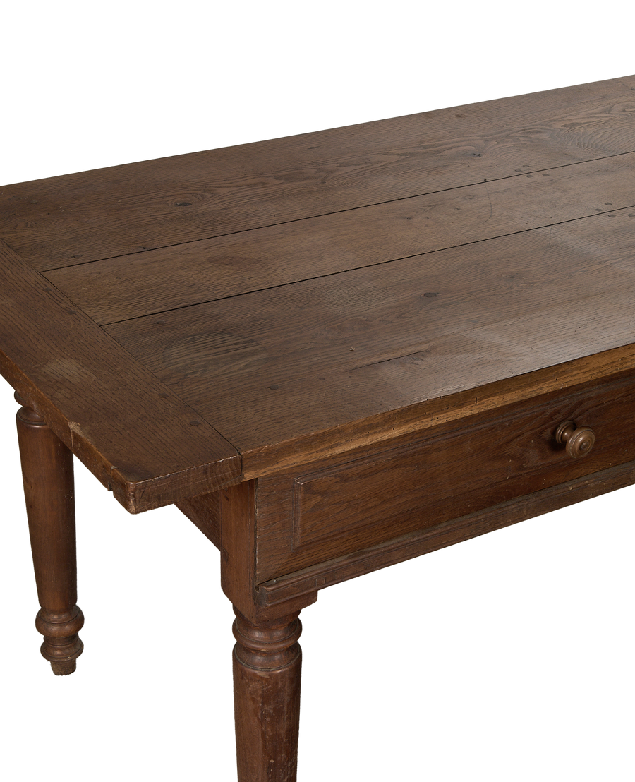 Vintage French oak draper's table showing plank top, drawer details, and turned legs.