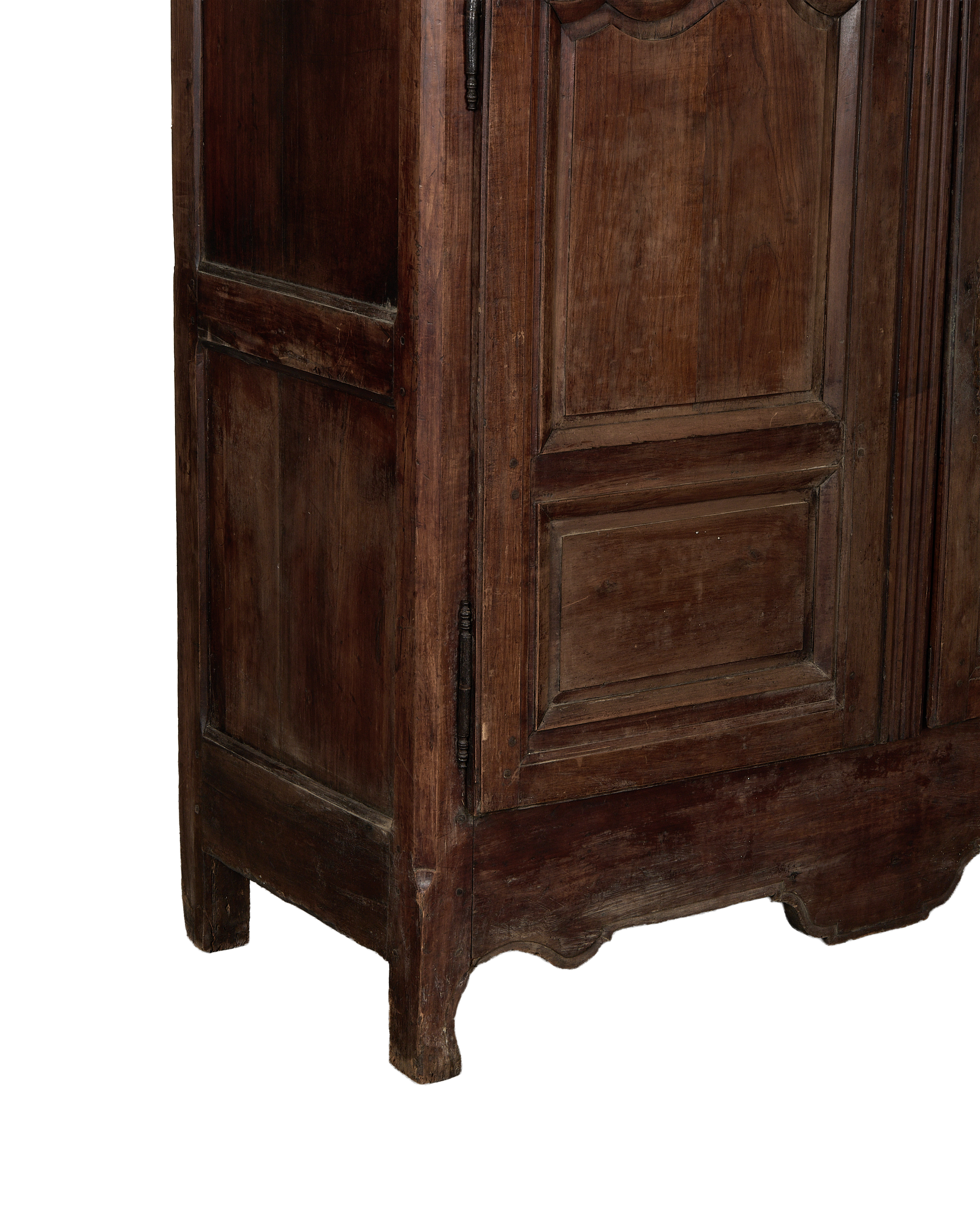 Vintage French oak armoire bottom, showing carved base, antique hinges, and aged wood.