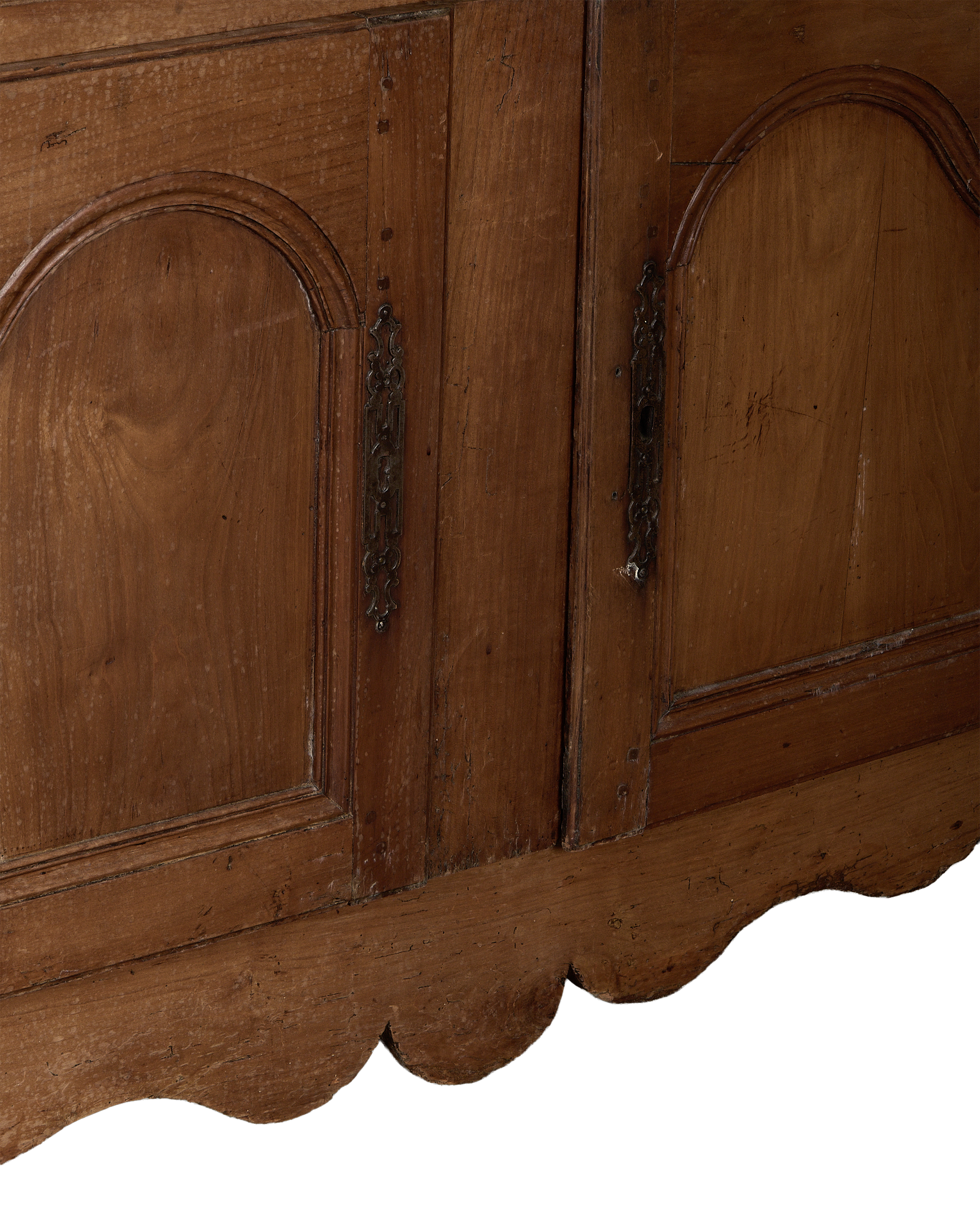 Vintage French oak sideboard, close up of ornate metal hardware and scalloped apron.