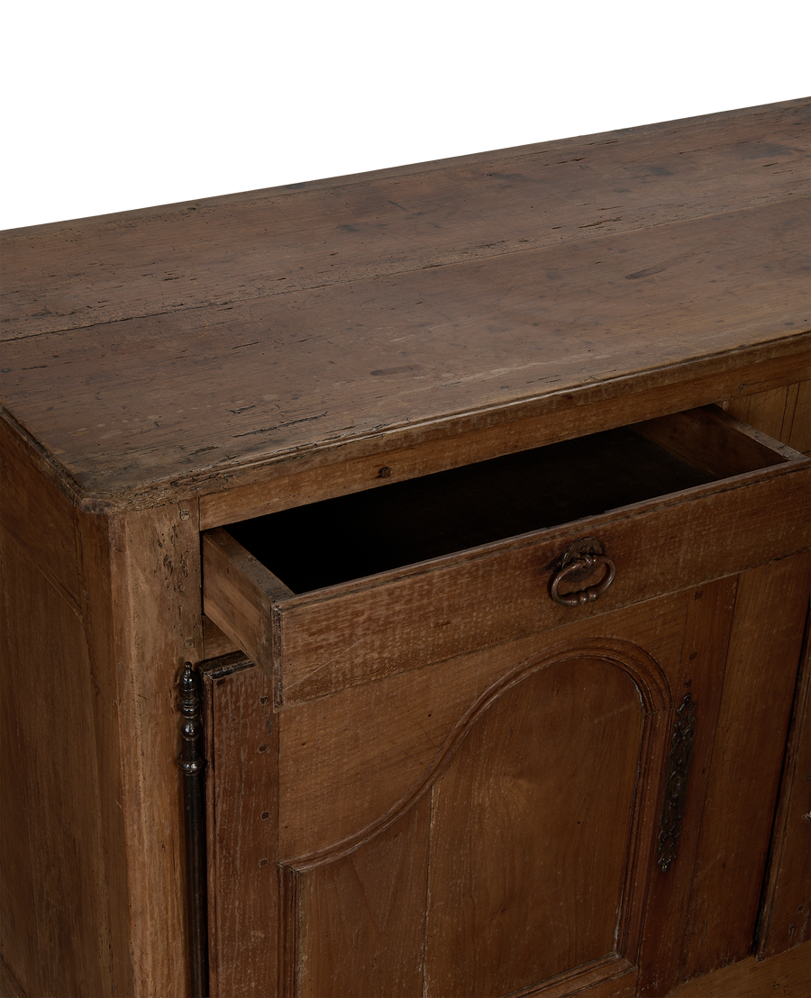 Open drawer of vintage French oak sideboard, showcasing interior and distressed wood texture.