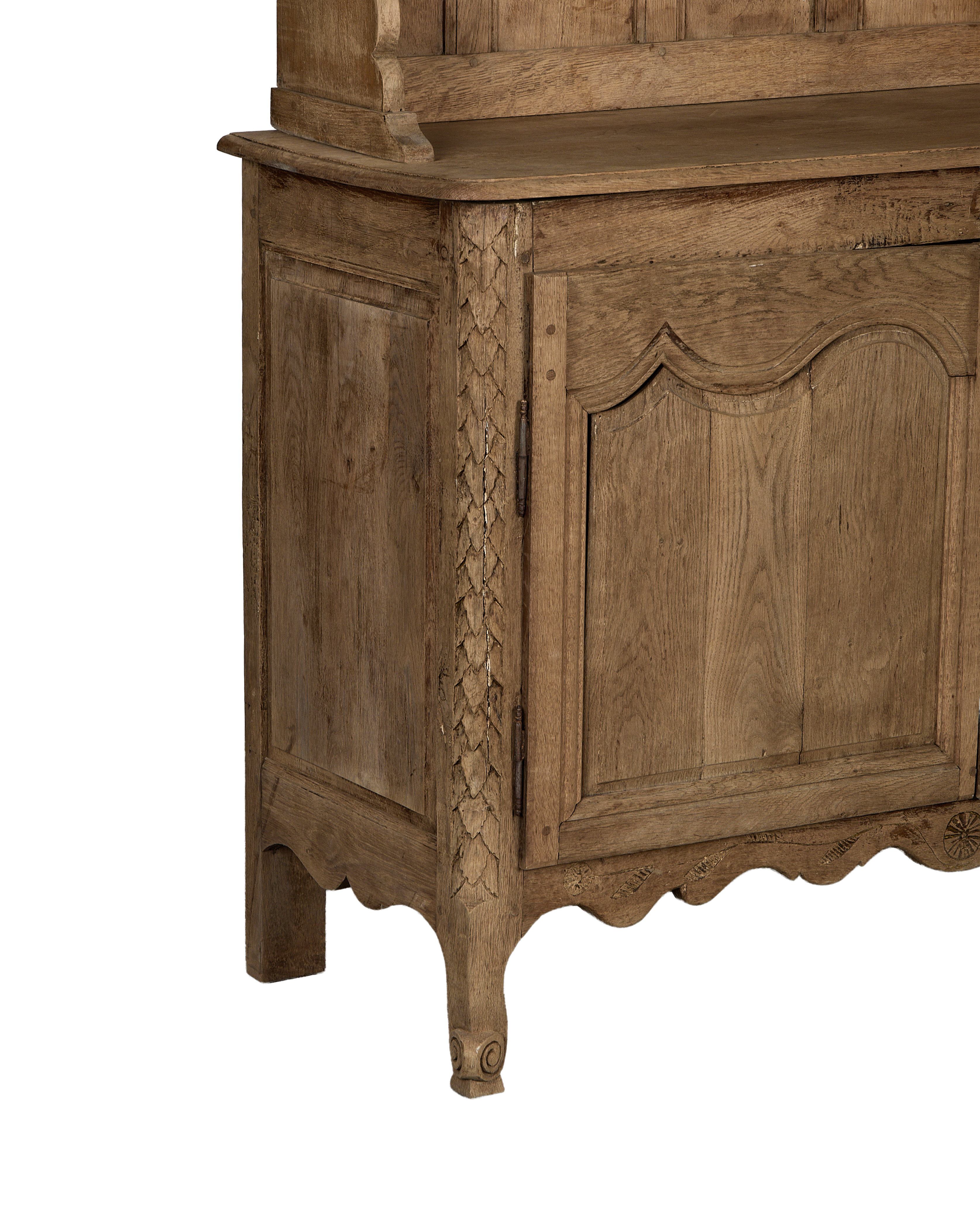 Vintage French oak china cabinet's intricate carved details, lower door, and curved foot.