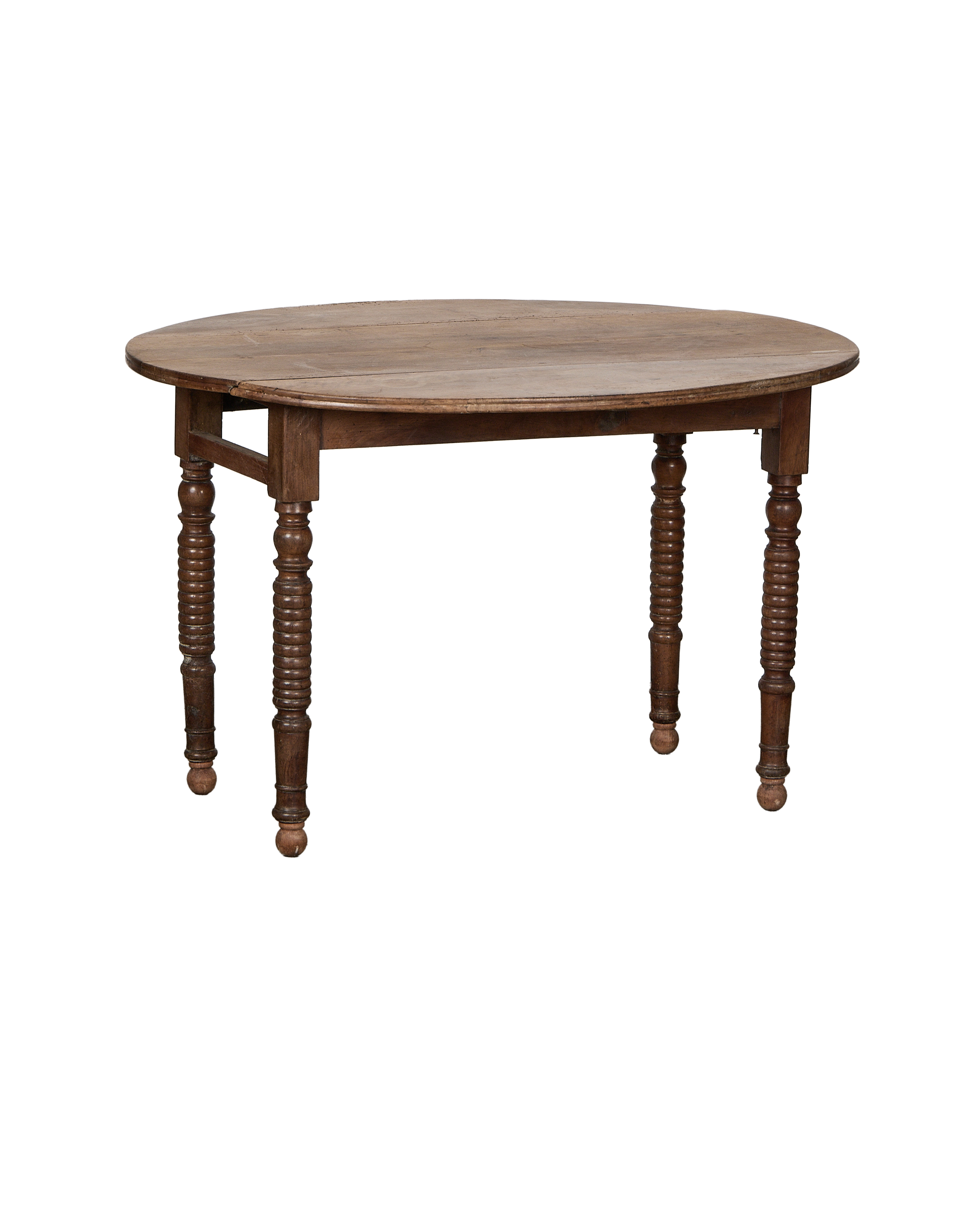Vintage French oak drop leaf table showcasing turned legs and rustic wood texture.