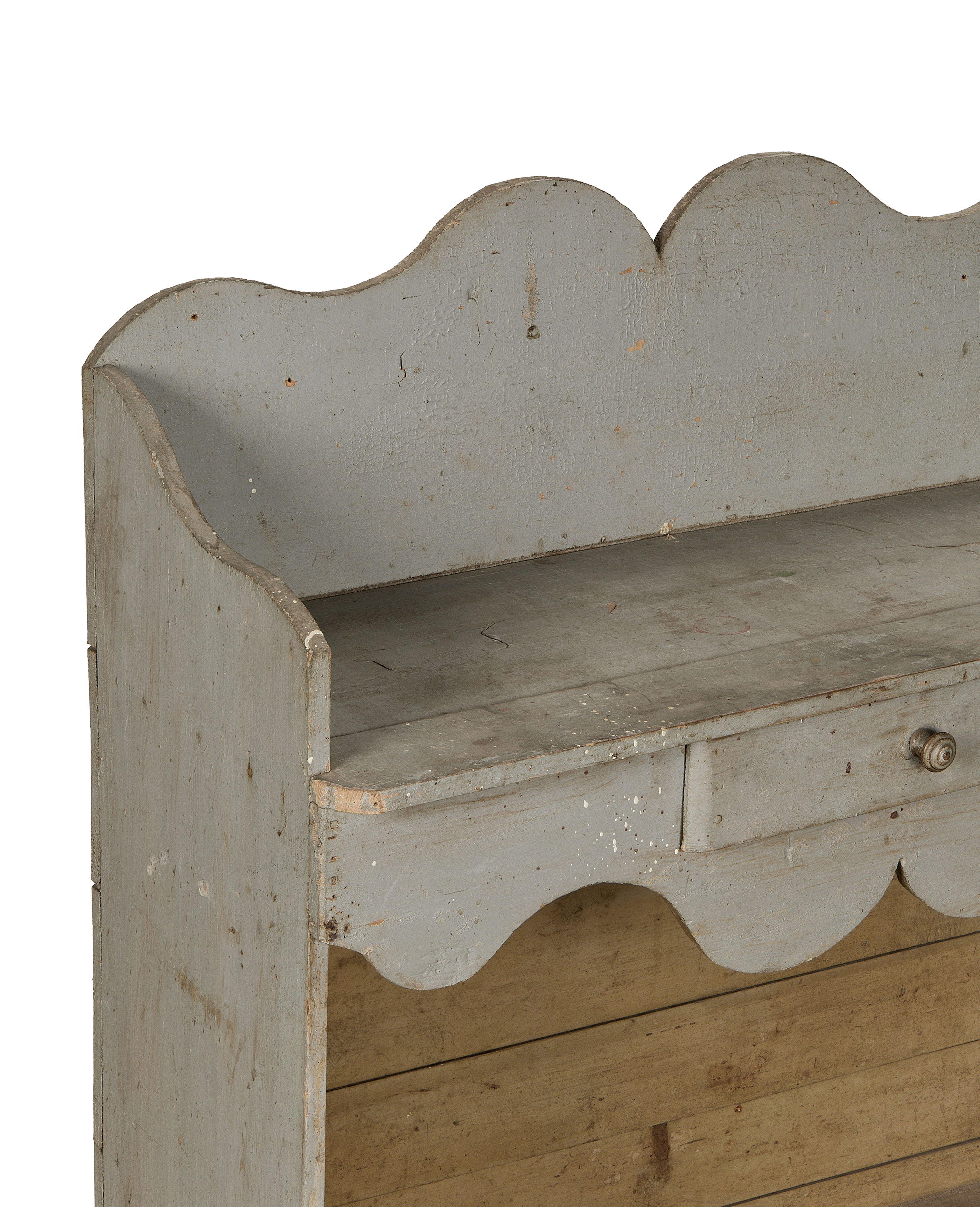 Vintage French oak scalloped shelving close-up, showing faded gray paint, drawer handle, and patina.