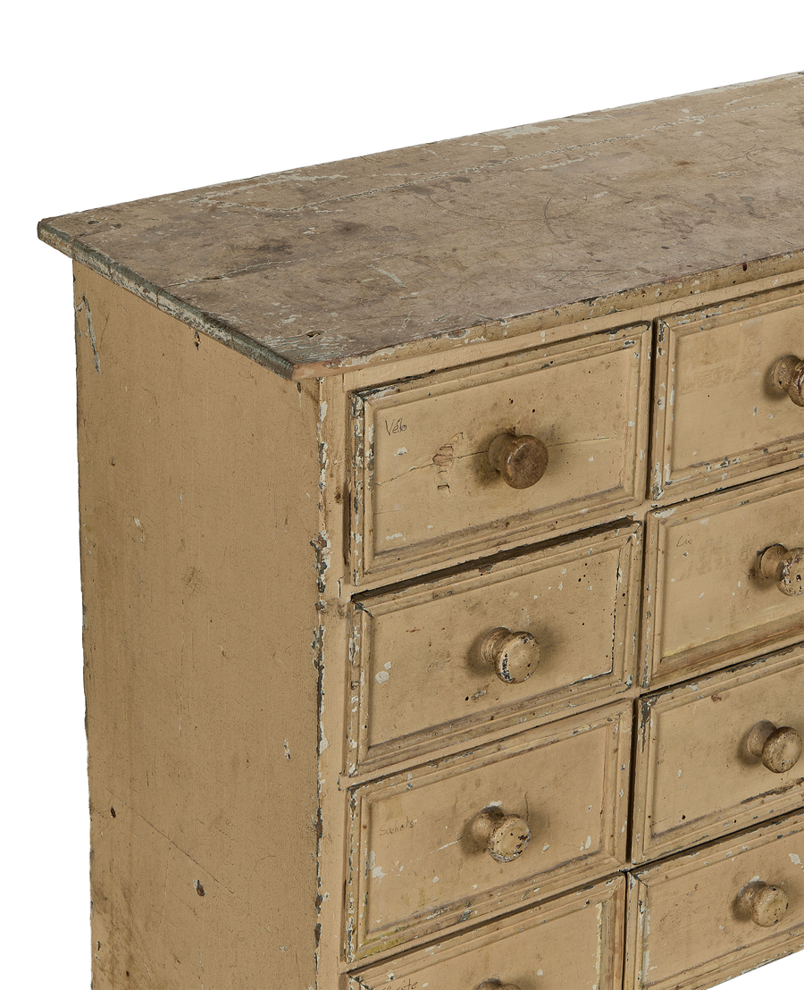 Distressed painted oak vintage French apothecary console details, showing texture and multiple drawers.