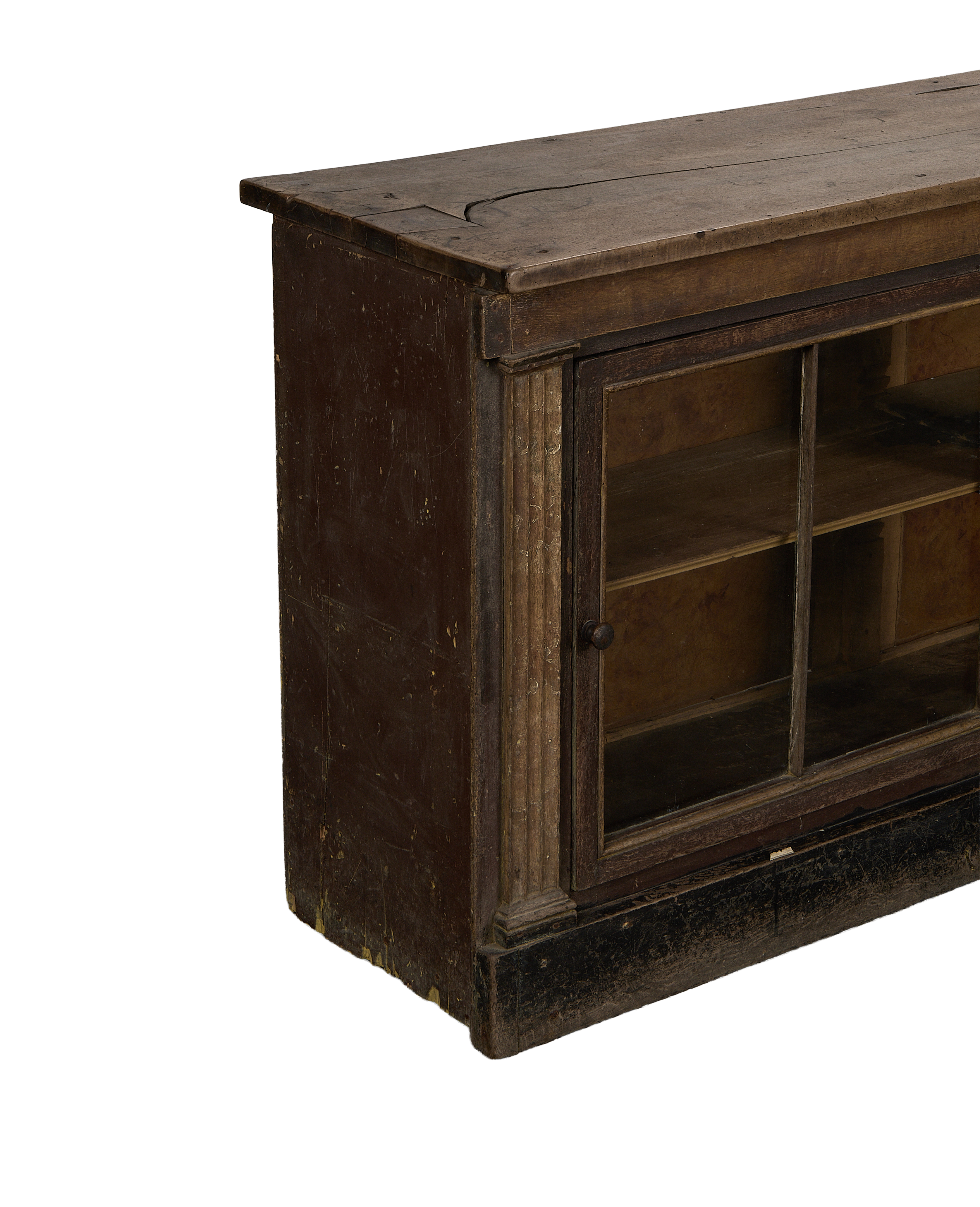Vintage French oak sideboard, close up of distressed dark brown wood with glass cabinet door.