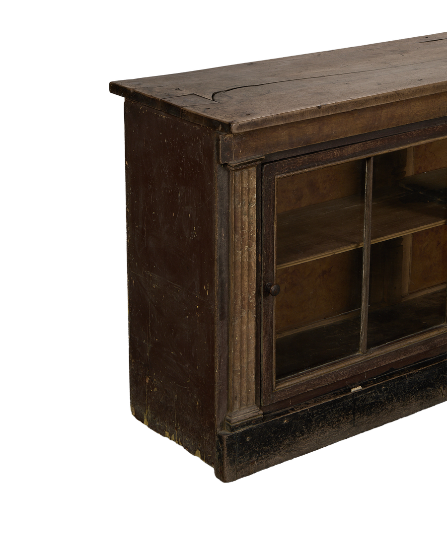 Vintage French oak sideboard, close up of distressed dark brown wood with glass cabinet door.