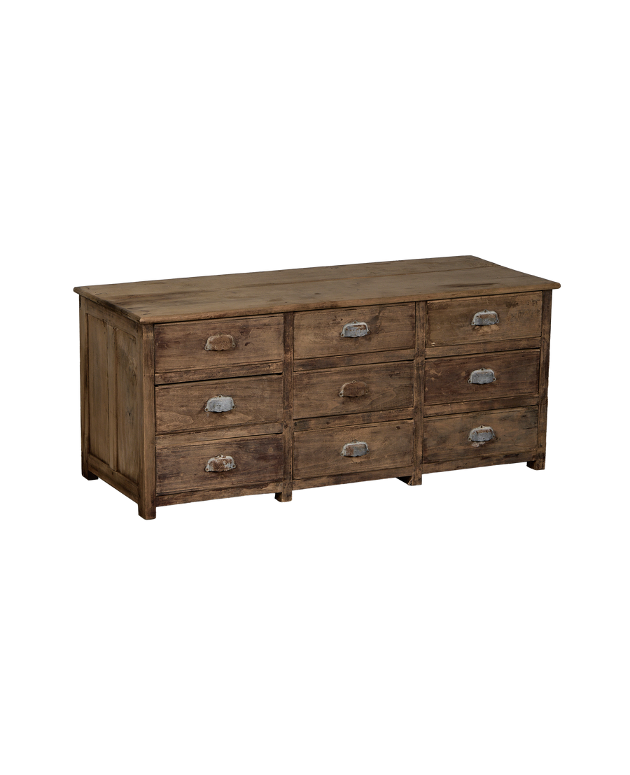 Vintage French oak sideboard displaying nine drawers with worn metal pulls, showing natural distressing.