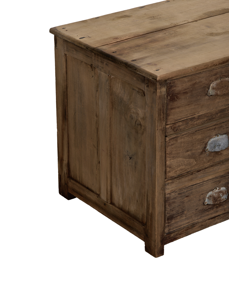 Vintage French oak drawer sideboard, angled detail of rustic wood grain, metal pulls.