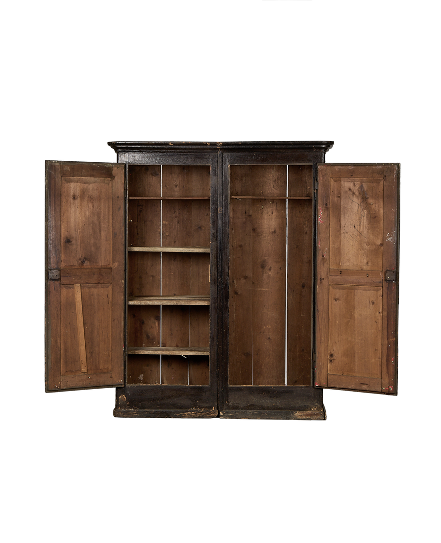 Vintage Parisian oak armoire, doors open revealing rustic interior shelves and distressed finish details.