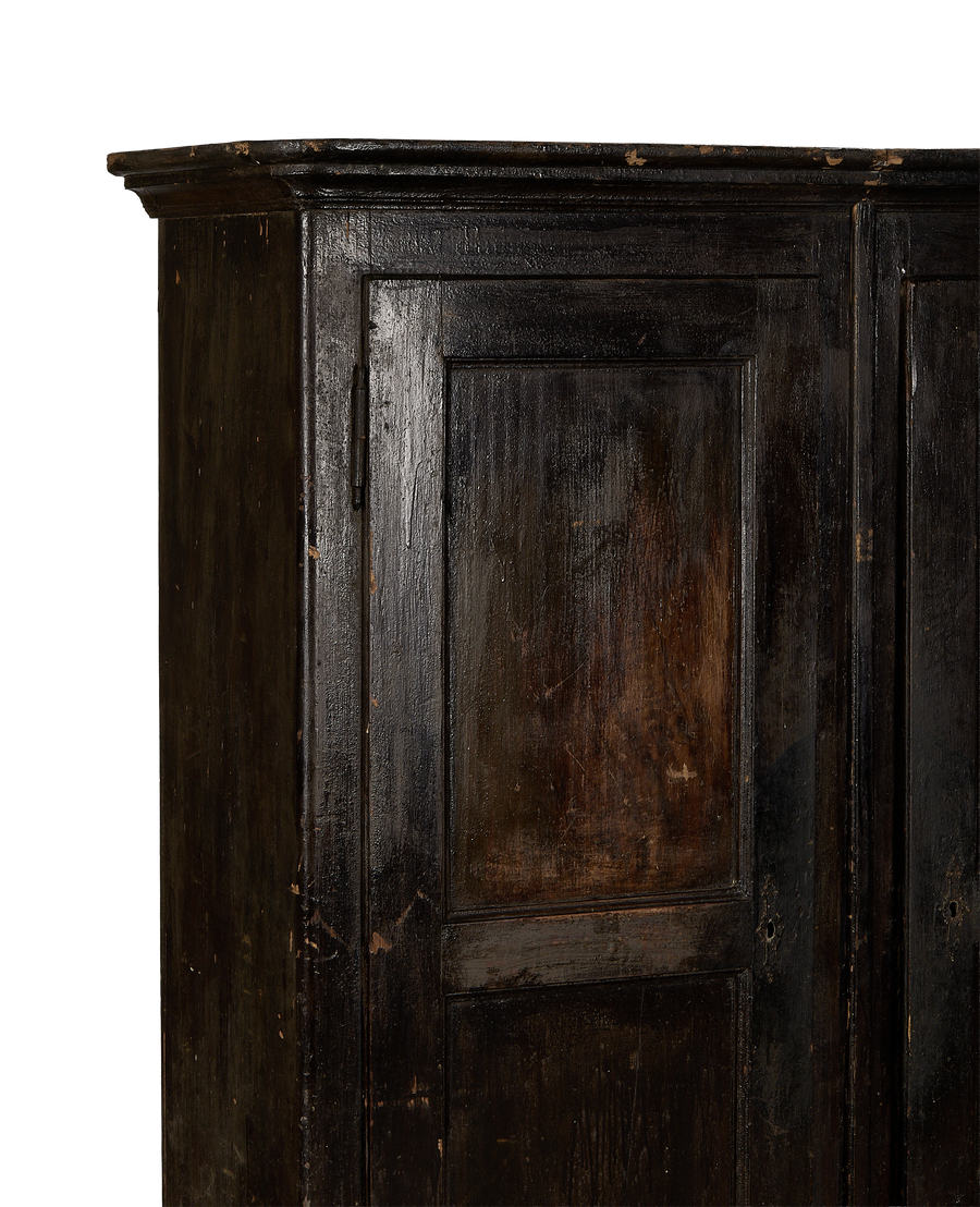 Vintage Parisian oak armoire, close-up of dark distressed wood and aged paneling, France.