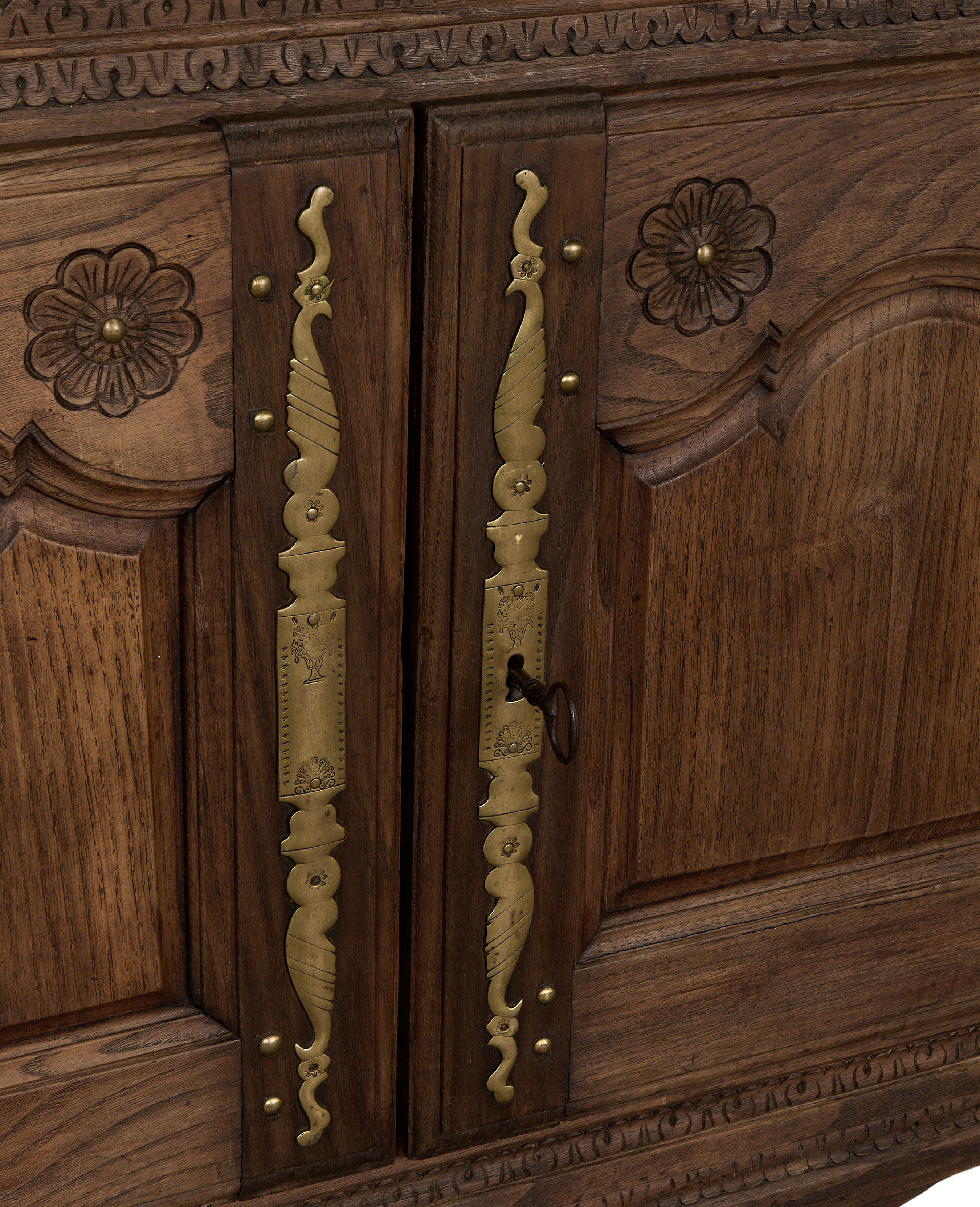 Vintage French oak sideboard, close up of ornate brass hardware and carving with key.