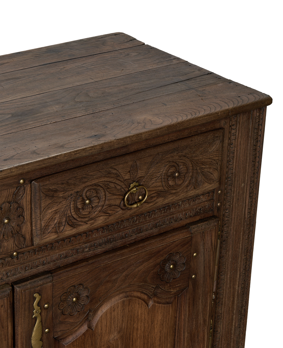 Vintage French oak sideboard, close up of carved floral details and rustic wooden top.