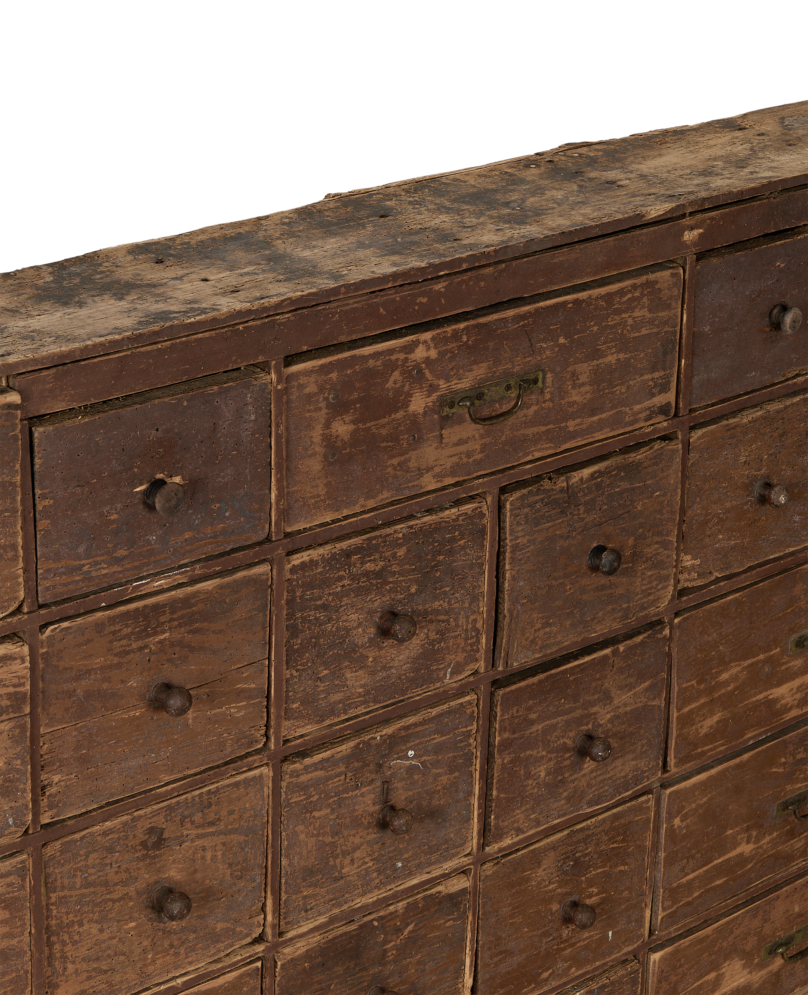Close-up of vintage French oak apothecary sideboard drawers, revealing distressed brown finish and knobs.