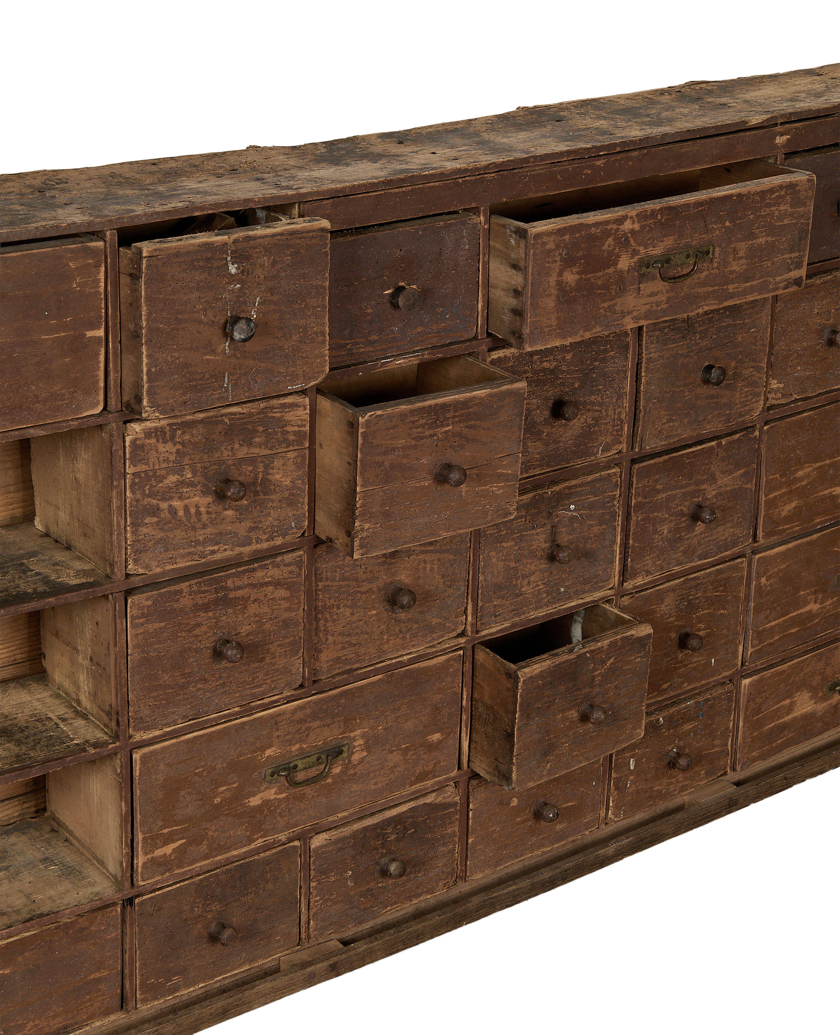Vintage French oak apothecary sideboard drawers, some ajar, showcasing distressed patina.