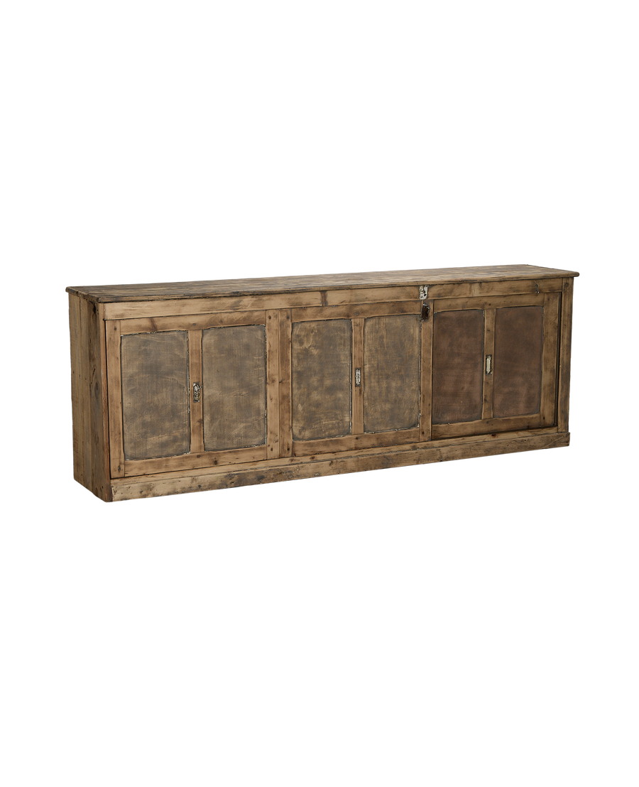 Vintage French oak sideboard angled view, showing four distressed doors, old latches, and rustic patina.