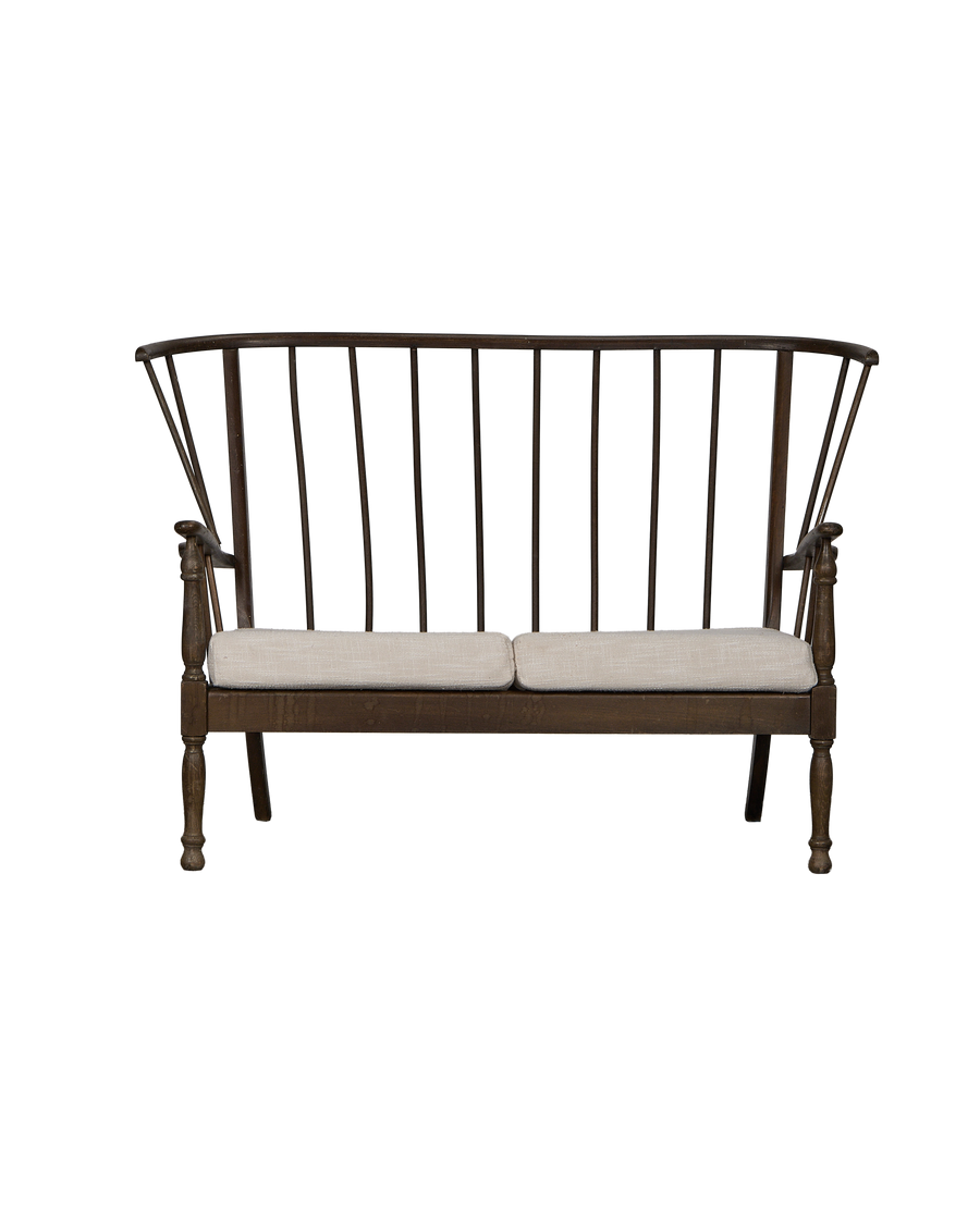 Vintage French oak lounge bench, full front view, showing spindle back and light linen cushions.