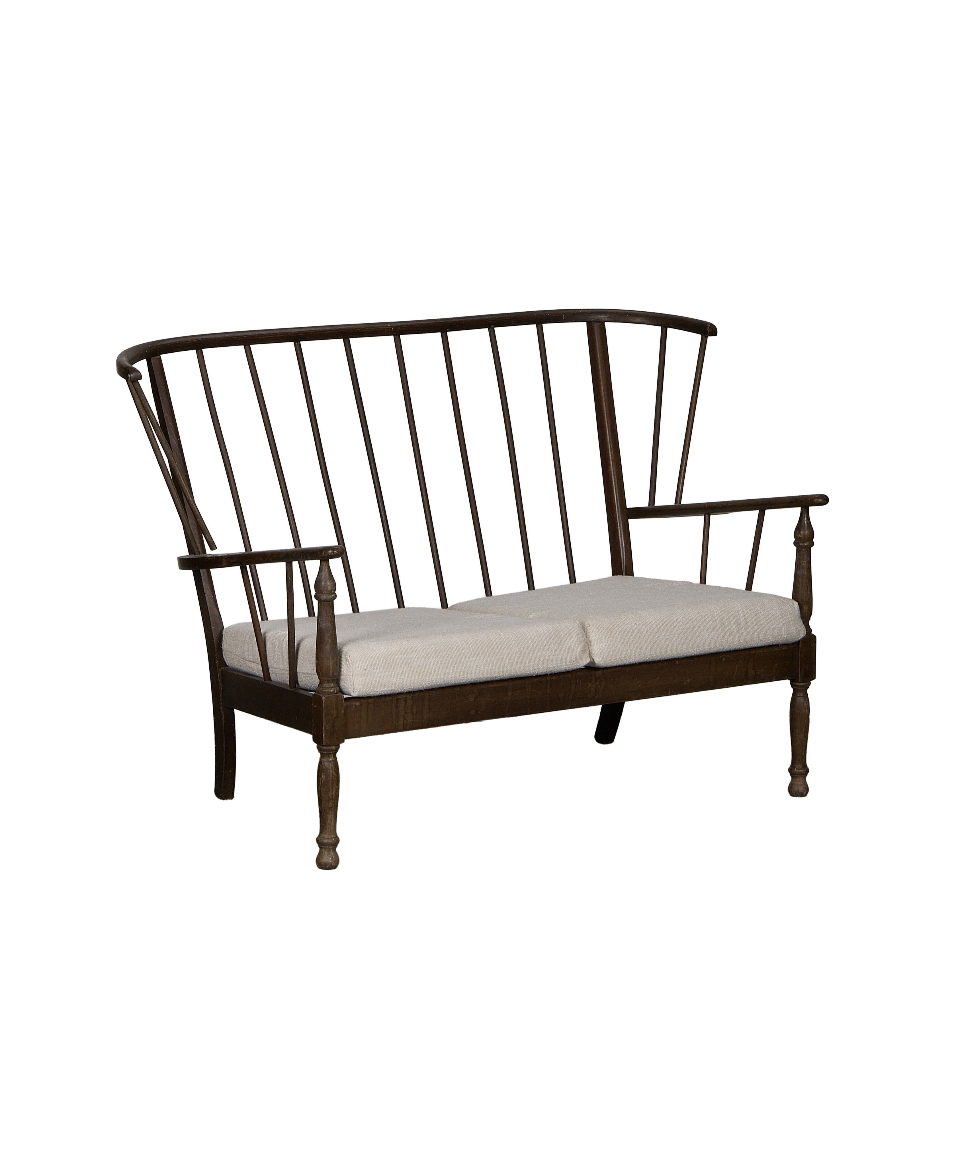 Vintage French oak lounge bench with spindle back and light linen cushions.