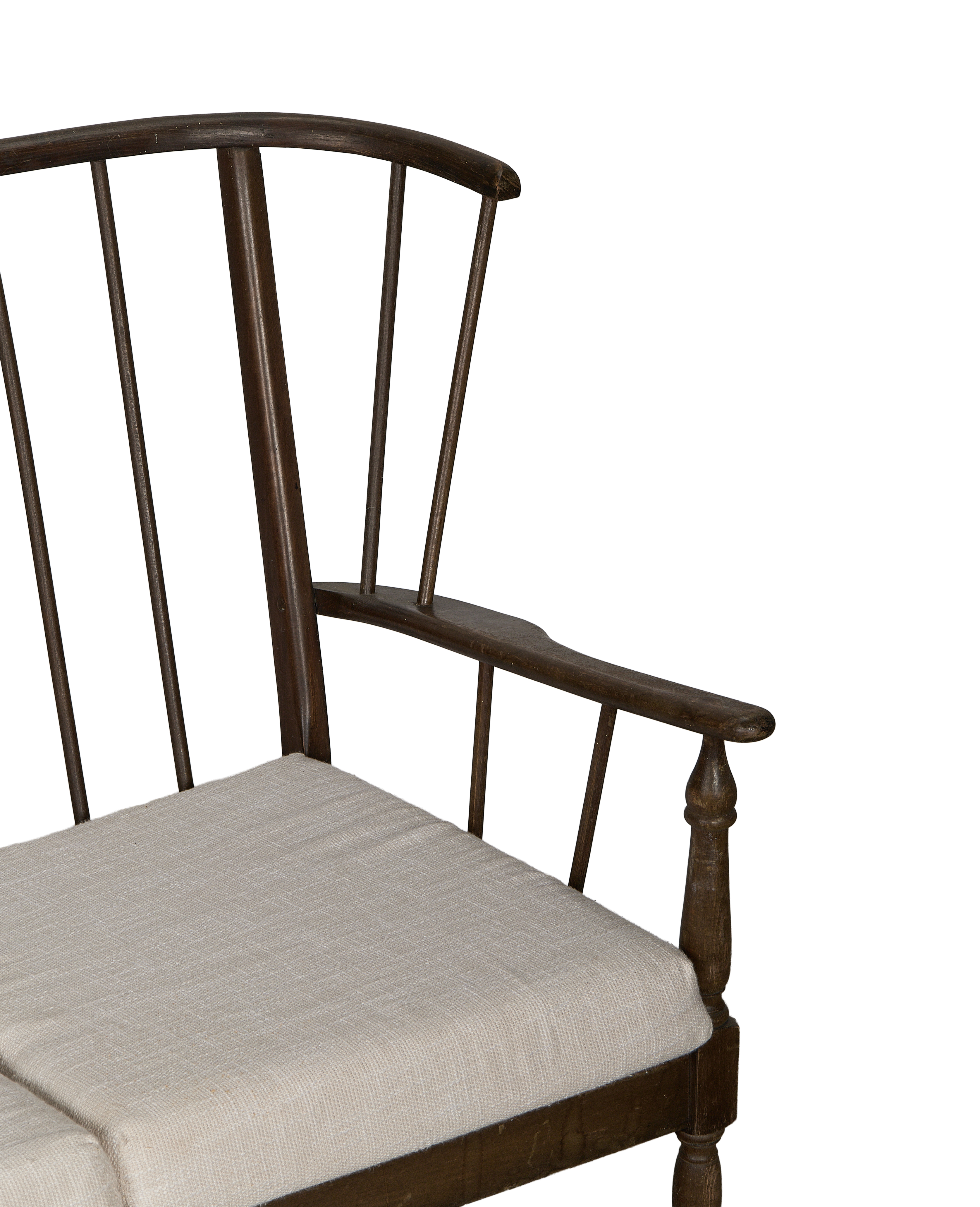 Close-up: Vintage French oak lounge bench, linen cushion, and spindle back detail.