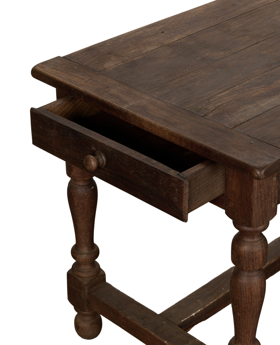 Vintage French oak draper's table with a partially open drawer showing its interior.