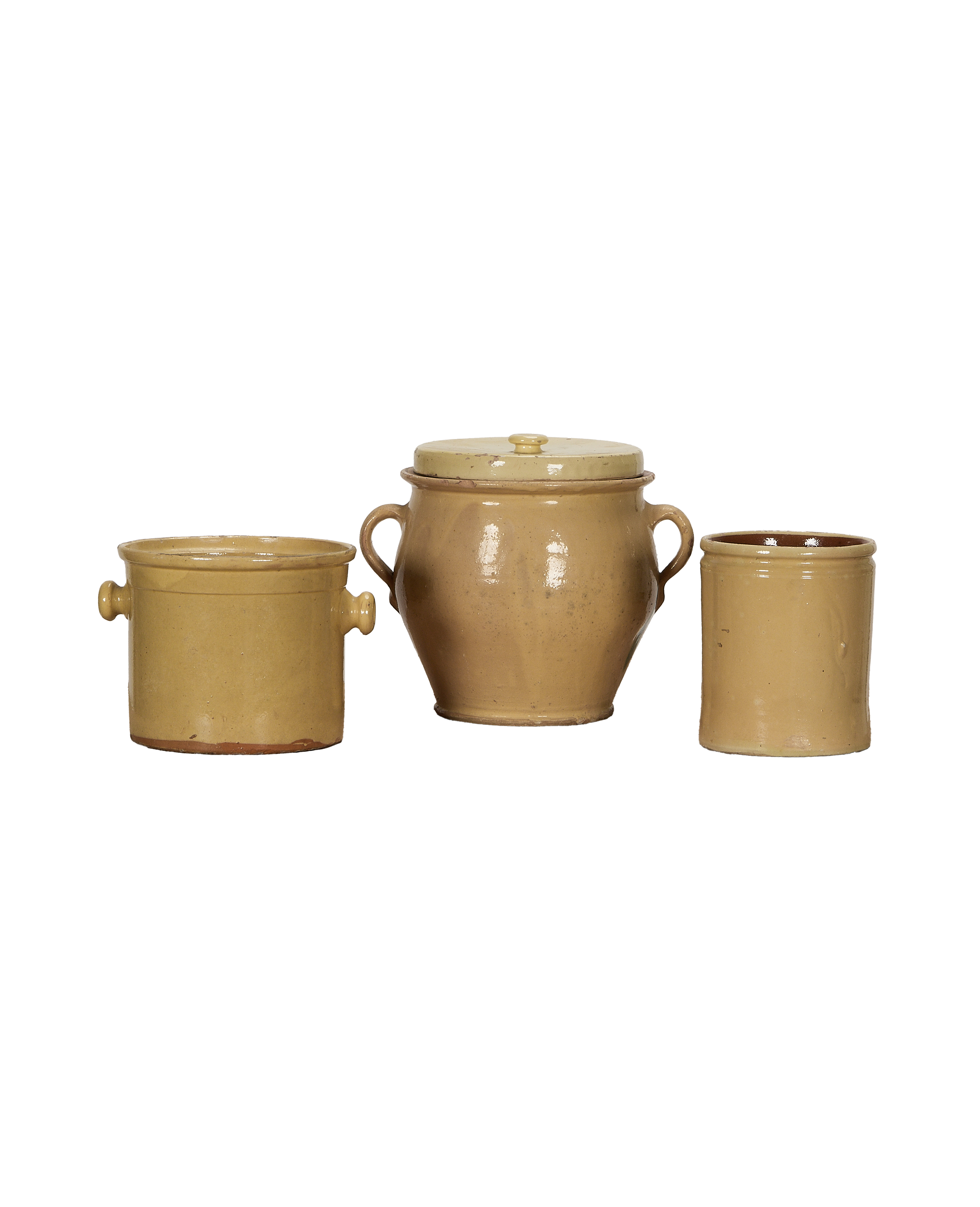 Three antique French confit crockery pieces, all with yellow-gold glaze on black background.