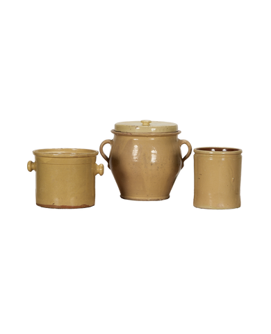 Three antique French confit crockery pieces, all with yellow-gold glaze on black background.