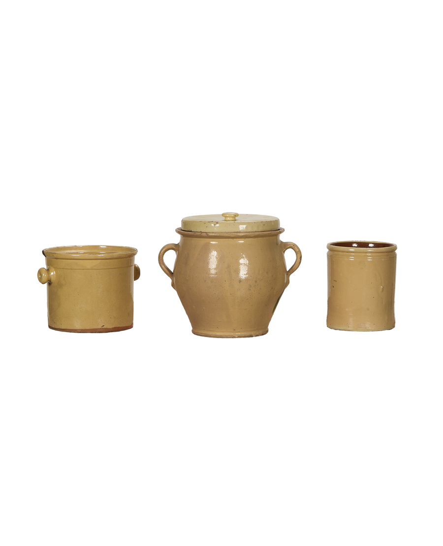 Three antique yellow glazed French confit pottery pieces in a single line.