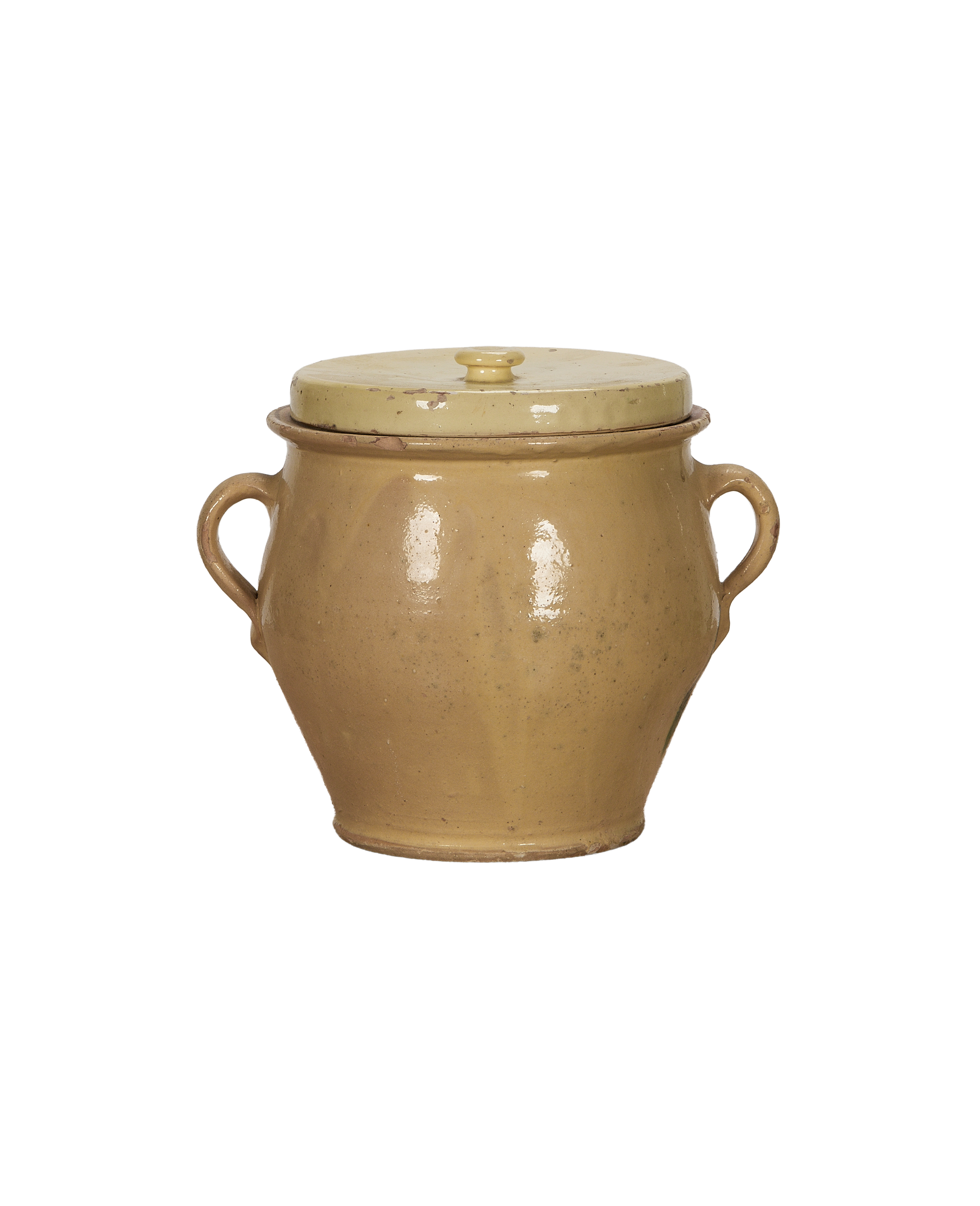 Antique French confit crock with distressed yellow glaze, two handles, and lid.