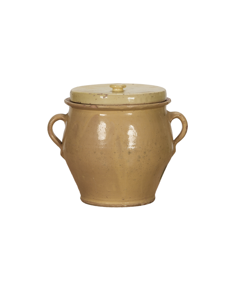 Antique French confit crock with distressed yellow glaze, two handles, and lid.