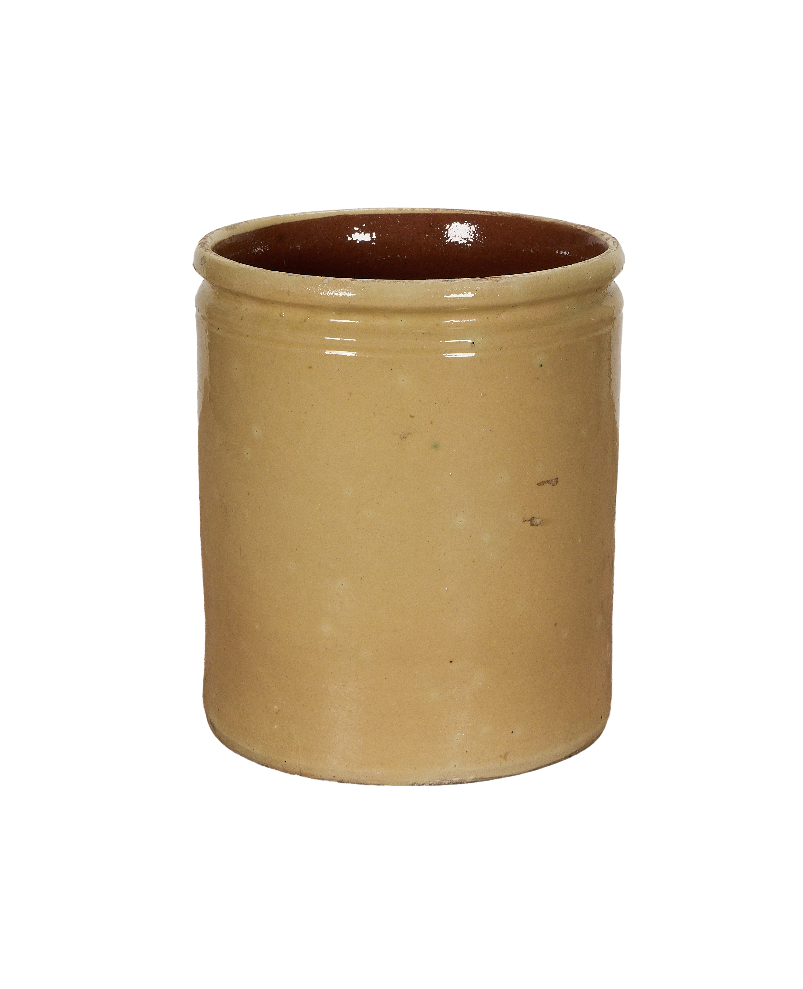 Antique French stoneware confit pot with mustard yellow glaze, close-up of rim interior.