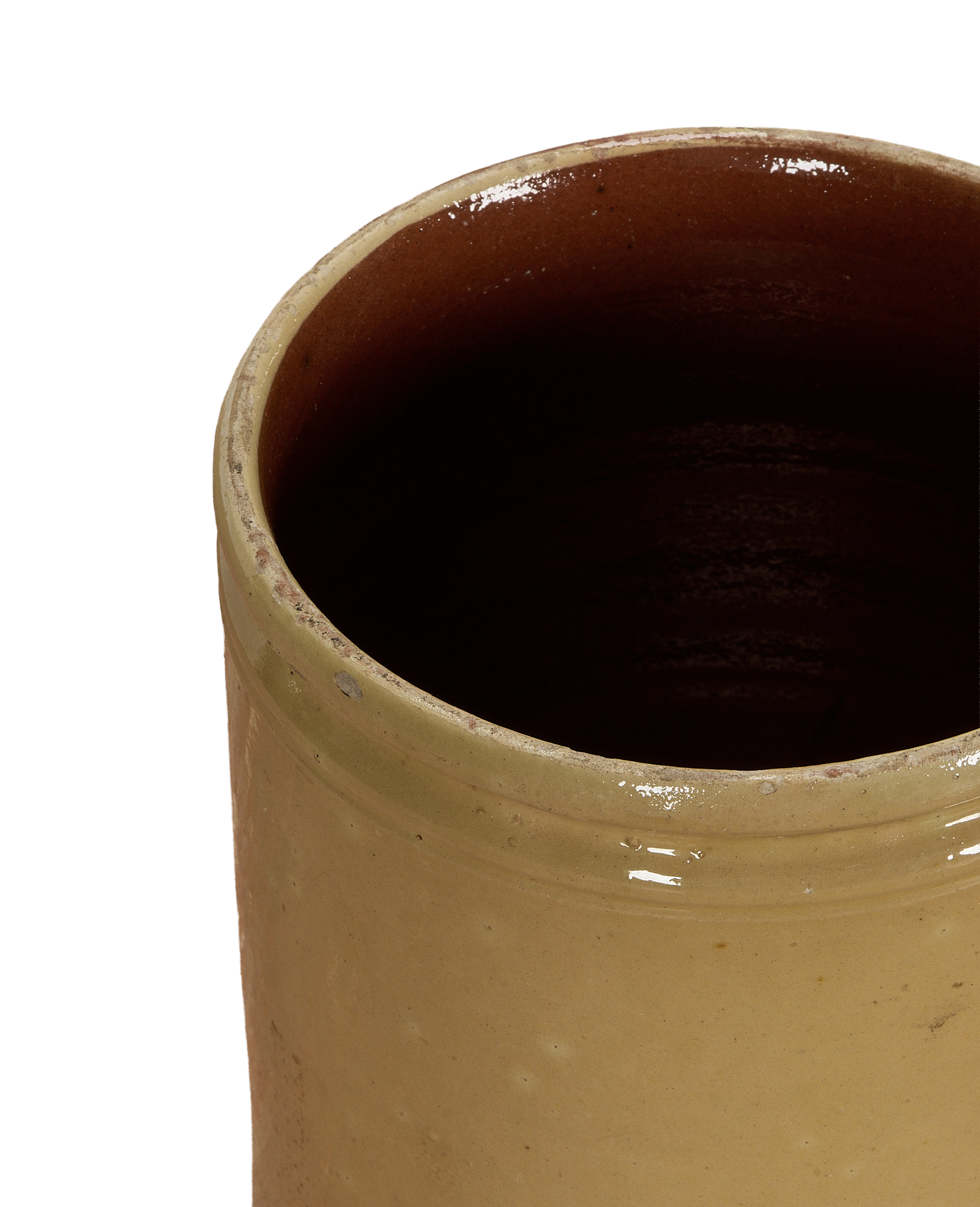 Antique French confit crock with textured yellow exterior glaze and brown interior.