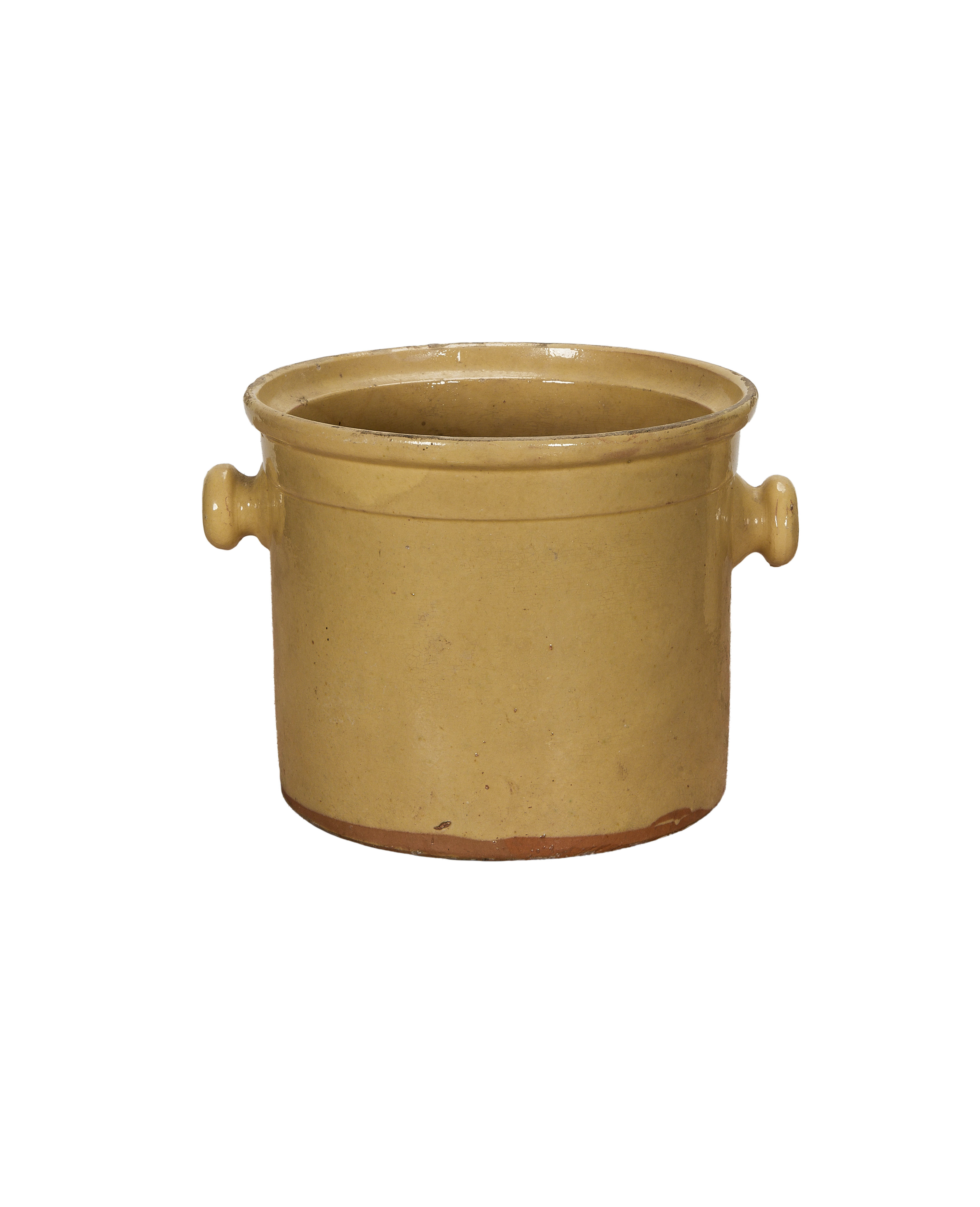 Antique French confit pot with warm yellow glaze, detailed side handles, and base.