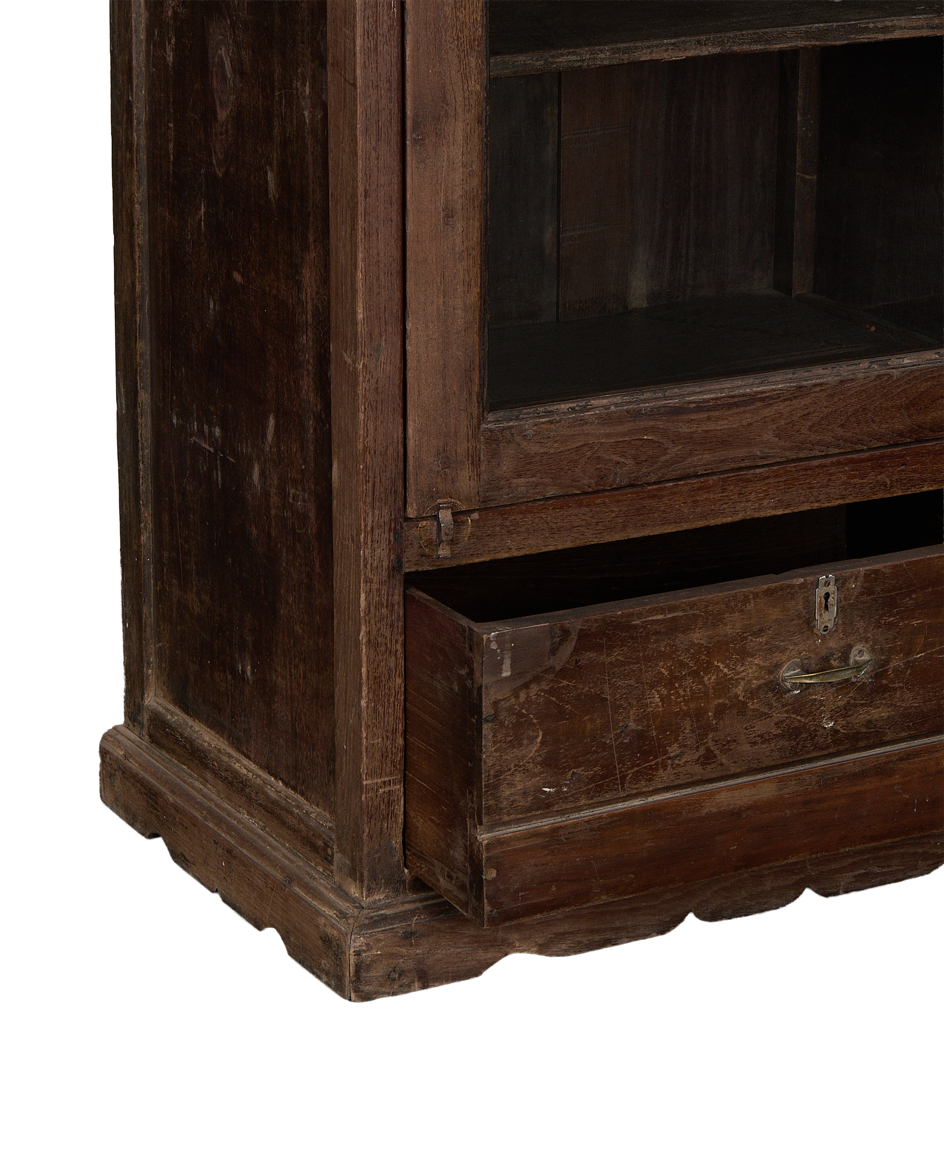 Vintage Indian oak cabinet drawer partially open, showing brass handle and weathered finish.