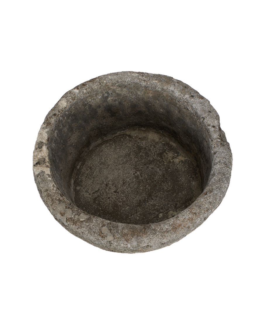Vintage Indonesian round limestone trough, top view showcasing aged interior texture.