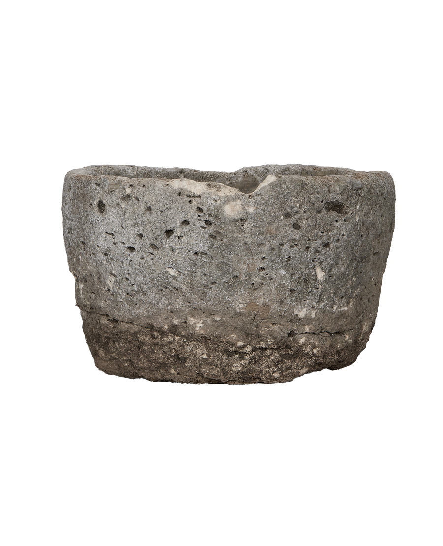 Vintage round limestone trough, side view revealing rough texture imperfections.