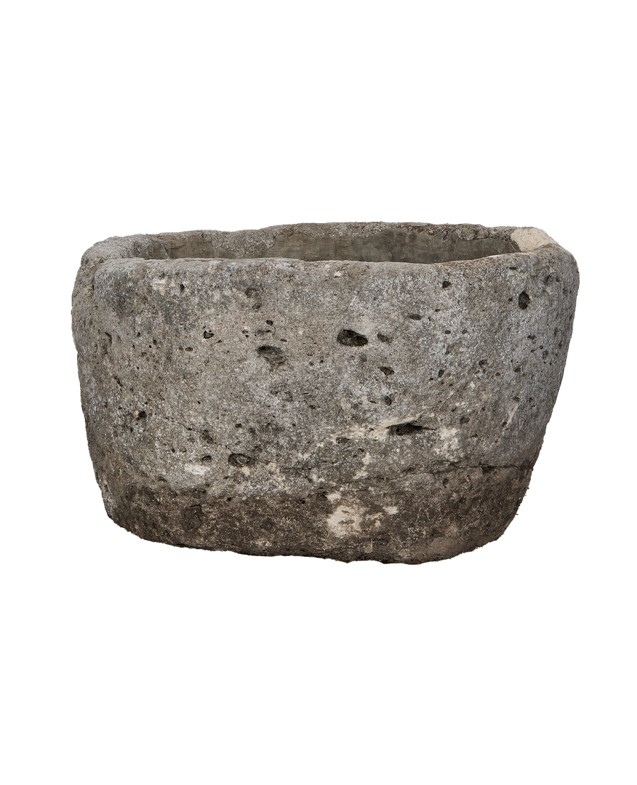 Vintage Indonesian limestone trough, round, showing weathered gray-brown exterior texture and uneven rim.