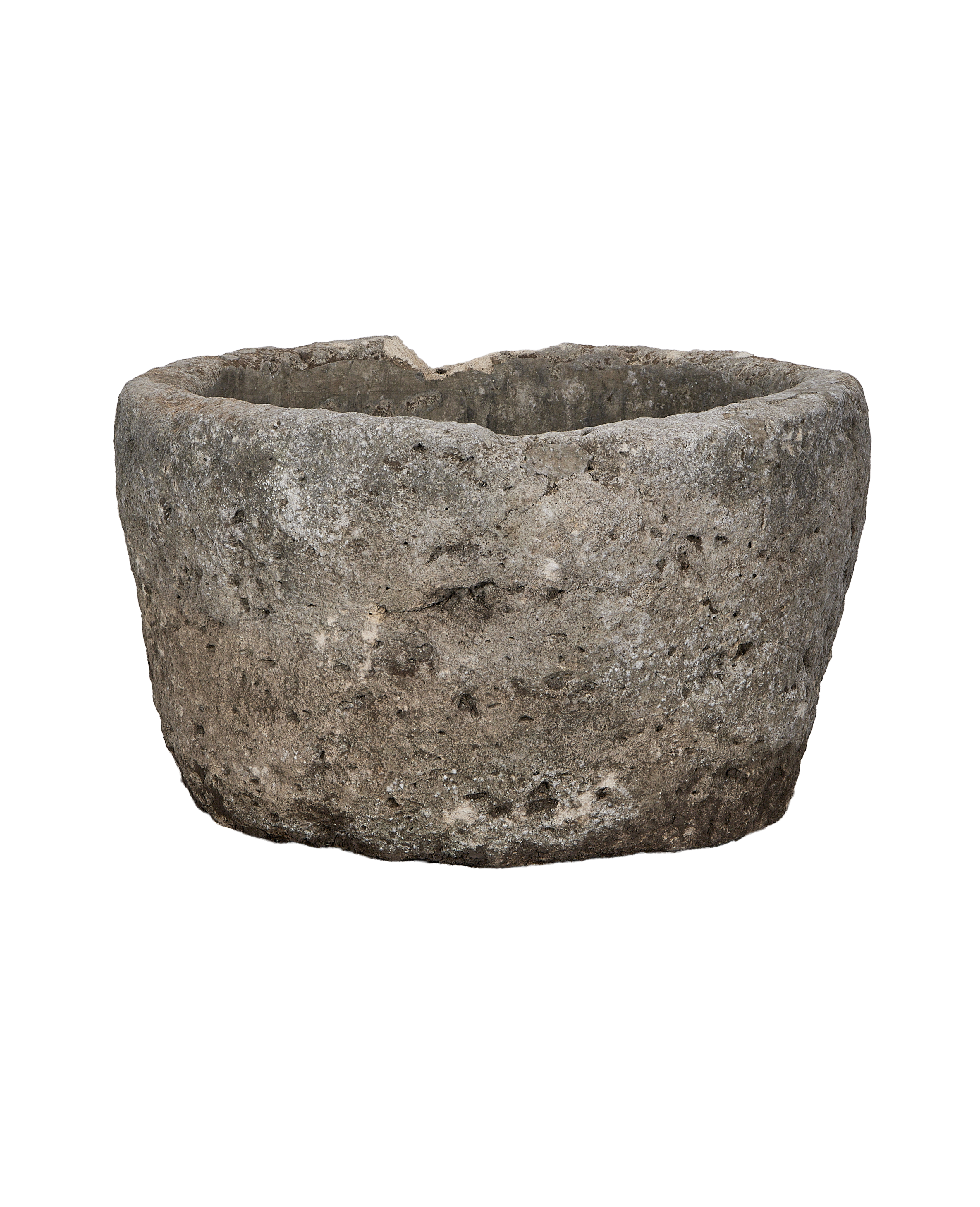 Vintage Indonesian round limestone trough, rugged exterior texture seen from the side.