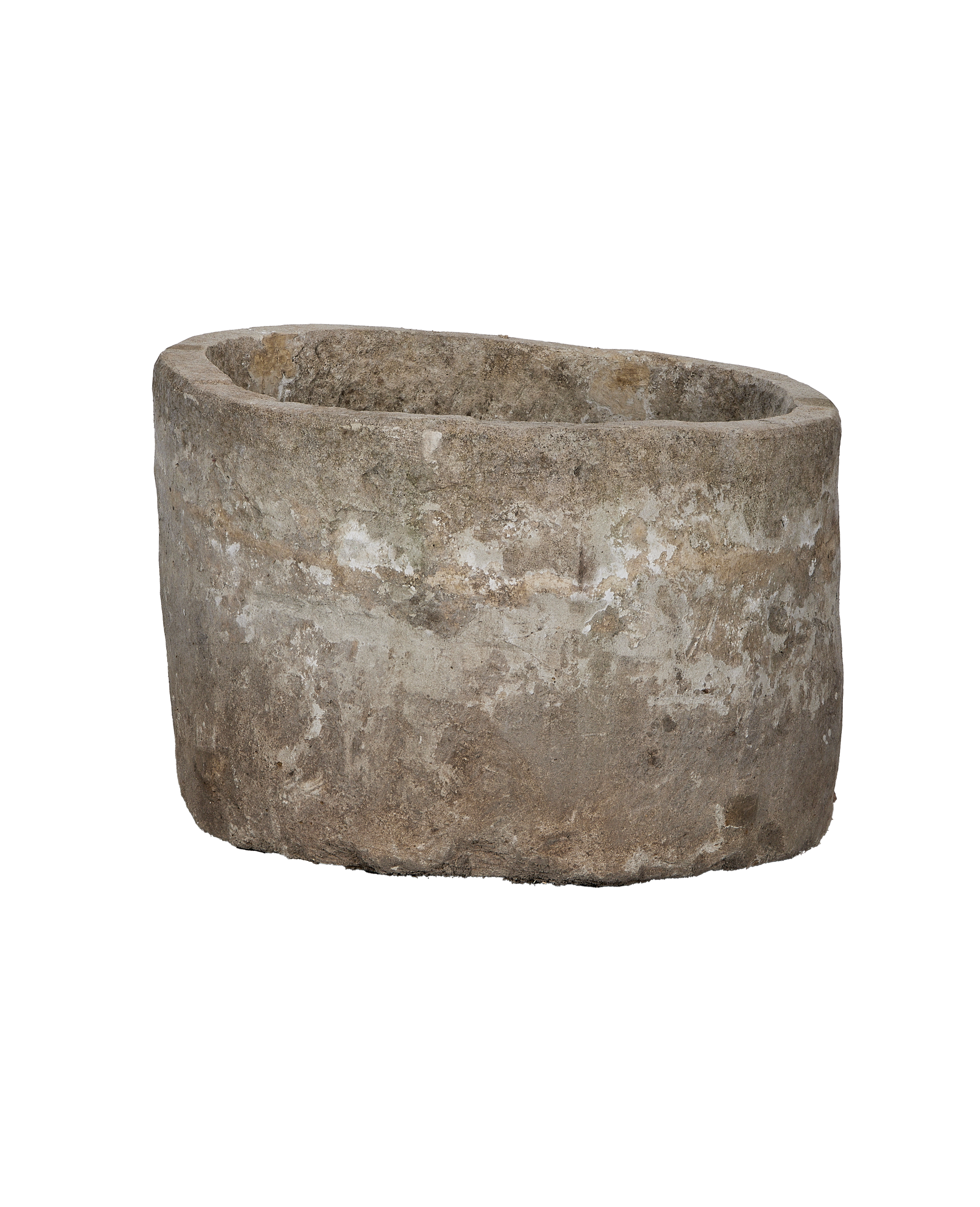Vintage Indonesian limestone trough, round, showing weathered exterior in natural light.