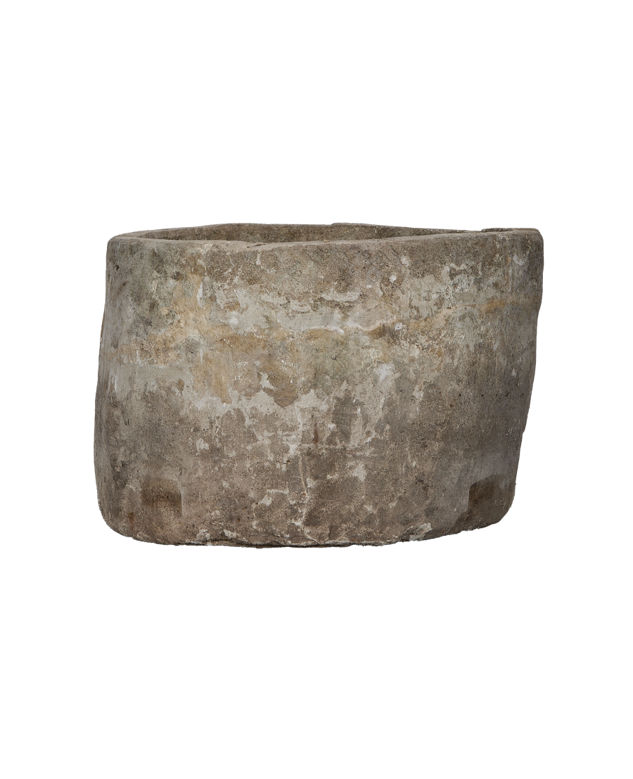 Vintage Indonesian round limestone trough, showing weathered texture and age with side view.