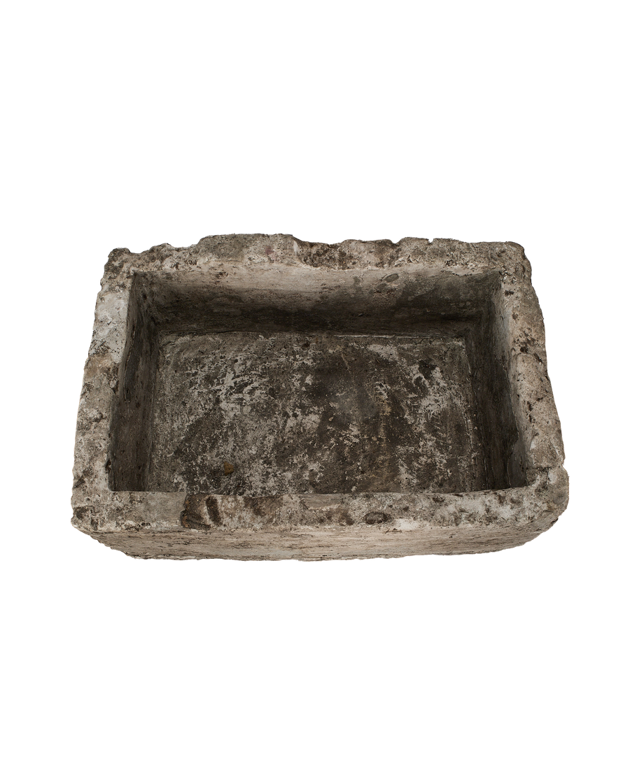 Vintage rectangular limestone trough, distressed texture, from above, showcasing rough interior and edges.