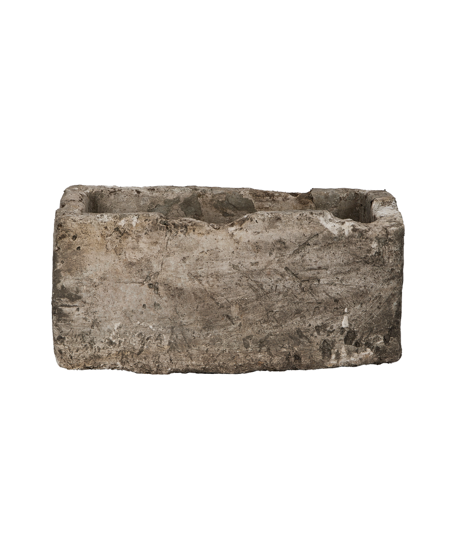 Vintage rectangular limestone trough, showing rough exterior with textured surface and weathered patina.