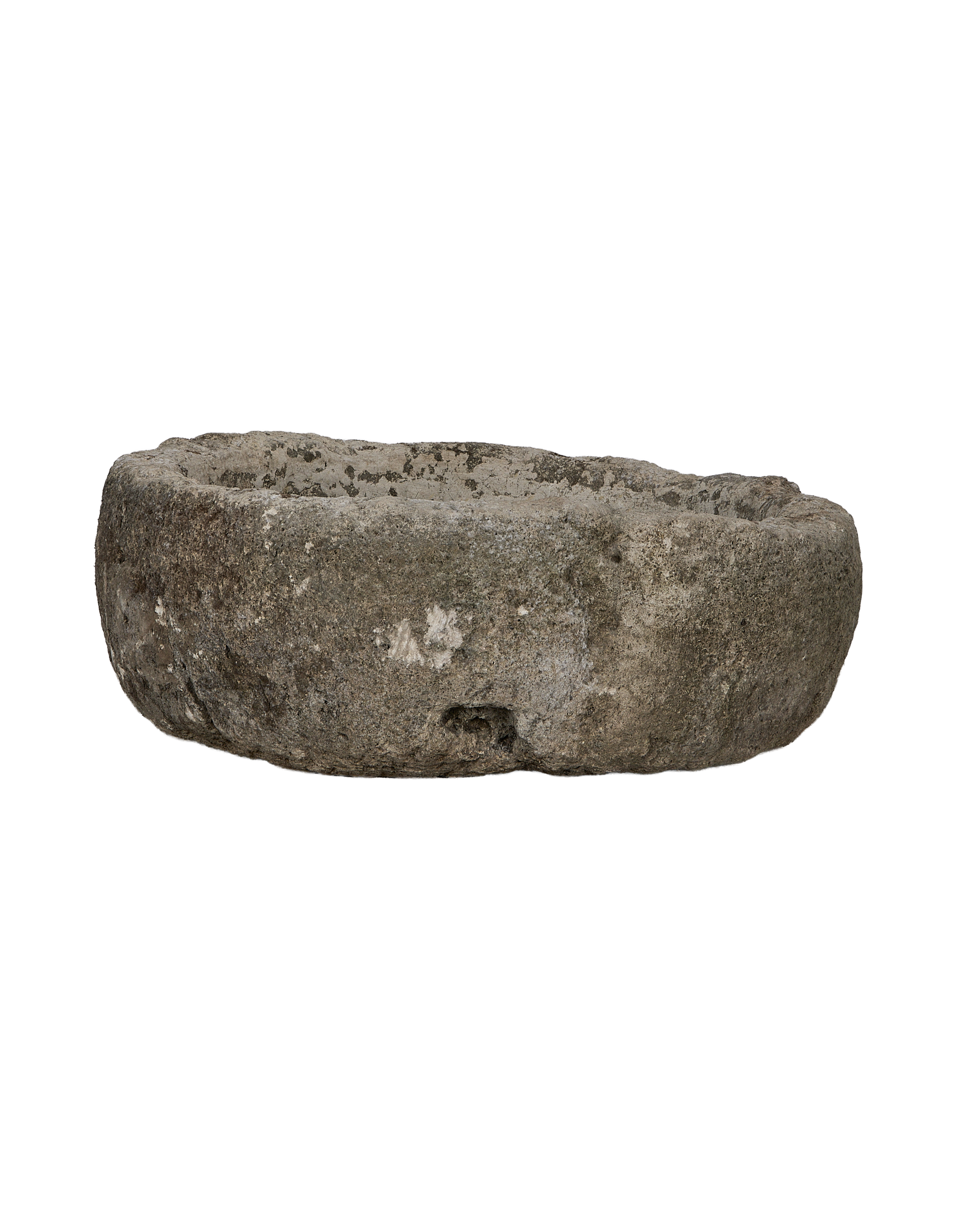 Vintage round Indonesian limestone trough, showing a side view of its worn, textured surface.
