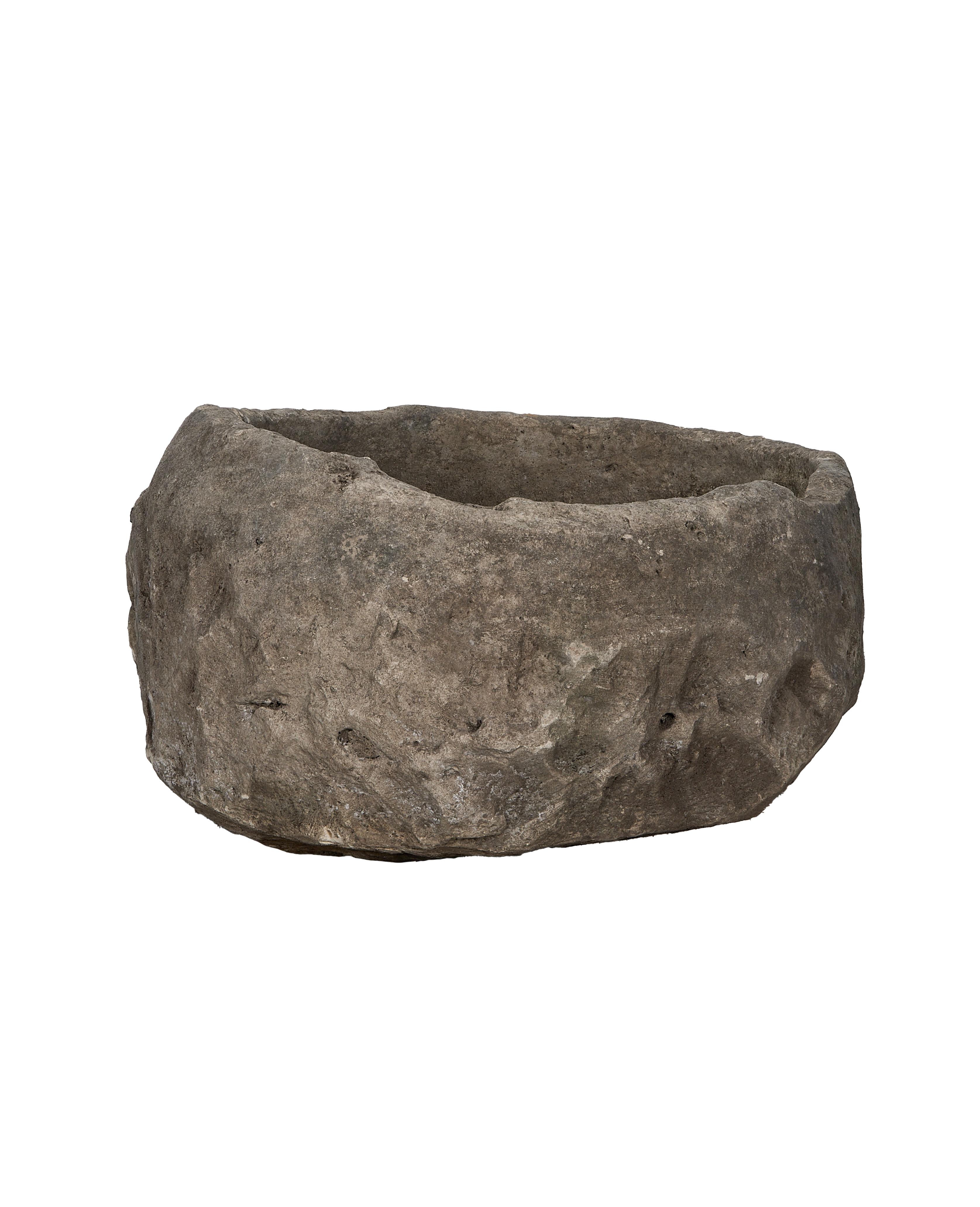 Vintage Indonesian round limestone trough, side profile showcasing rough hewn texture.